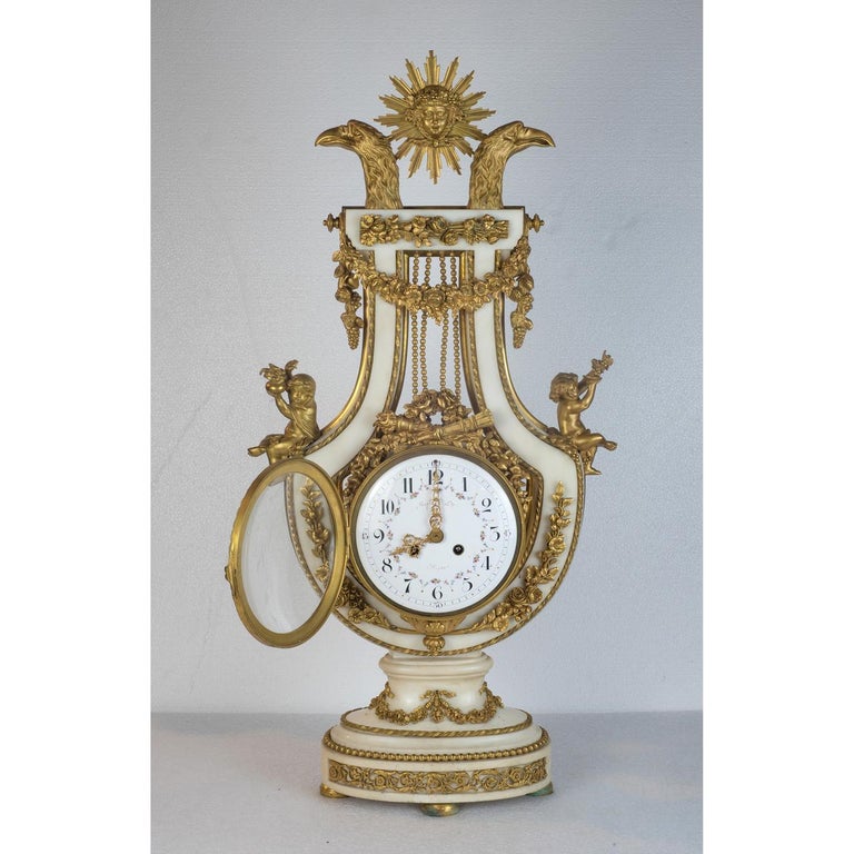 Fine French Lyre shaped marble and Ormolu Clock 

Origin:French

Date: Late 19th century

retailed by Maple & Co .

Dimensions: 29