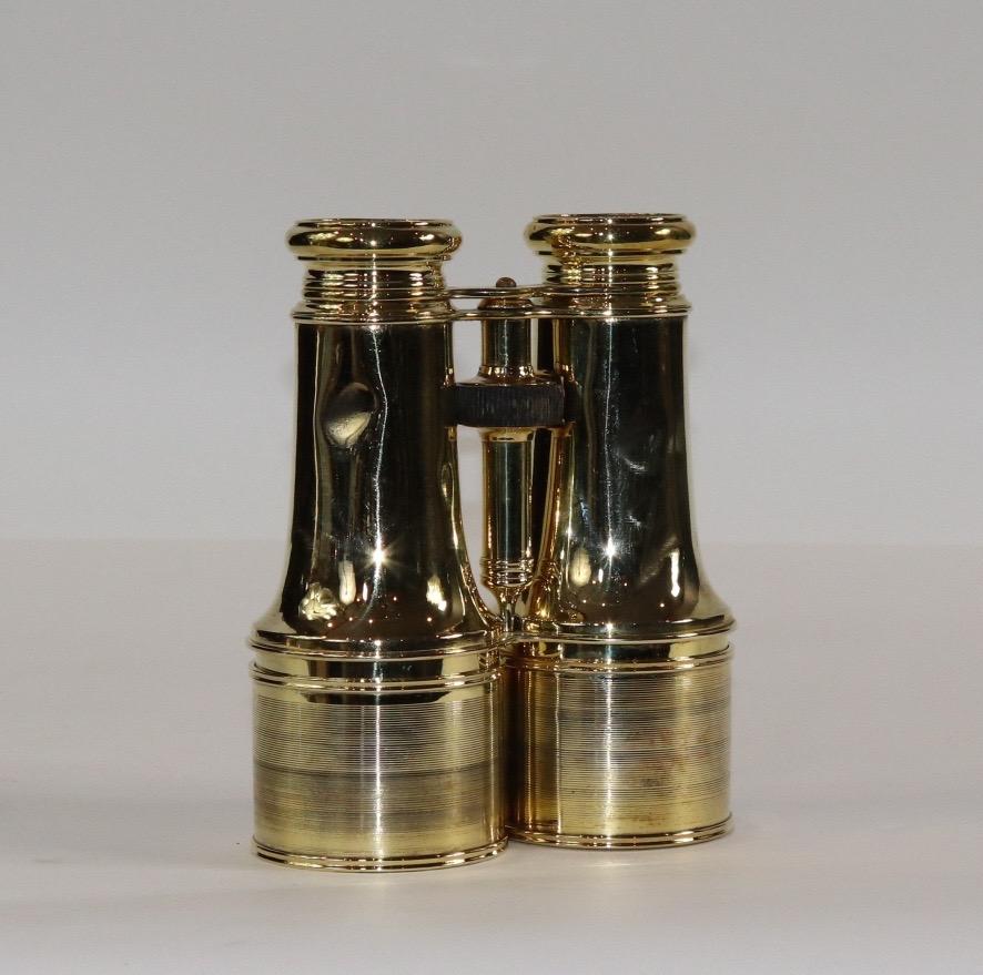 Pair of highly polished and lacquered French made yachting binoculars by Lemaire of Paris. With center focal knob. Small dent on barrel. Weight is 2 pounds. X-122