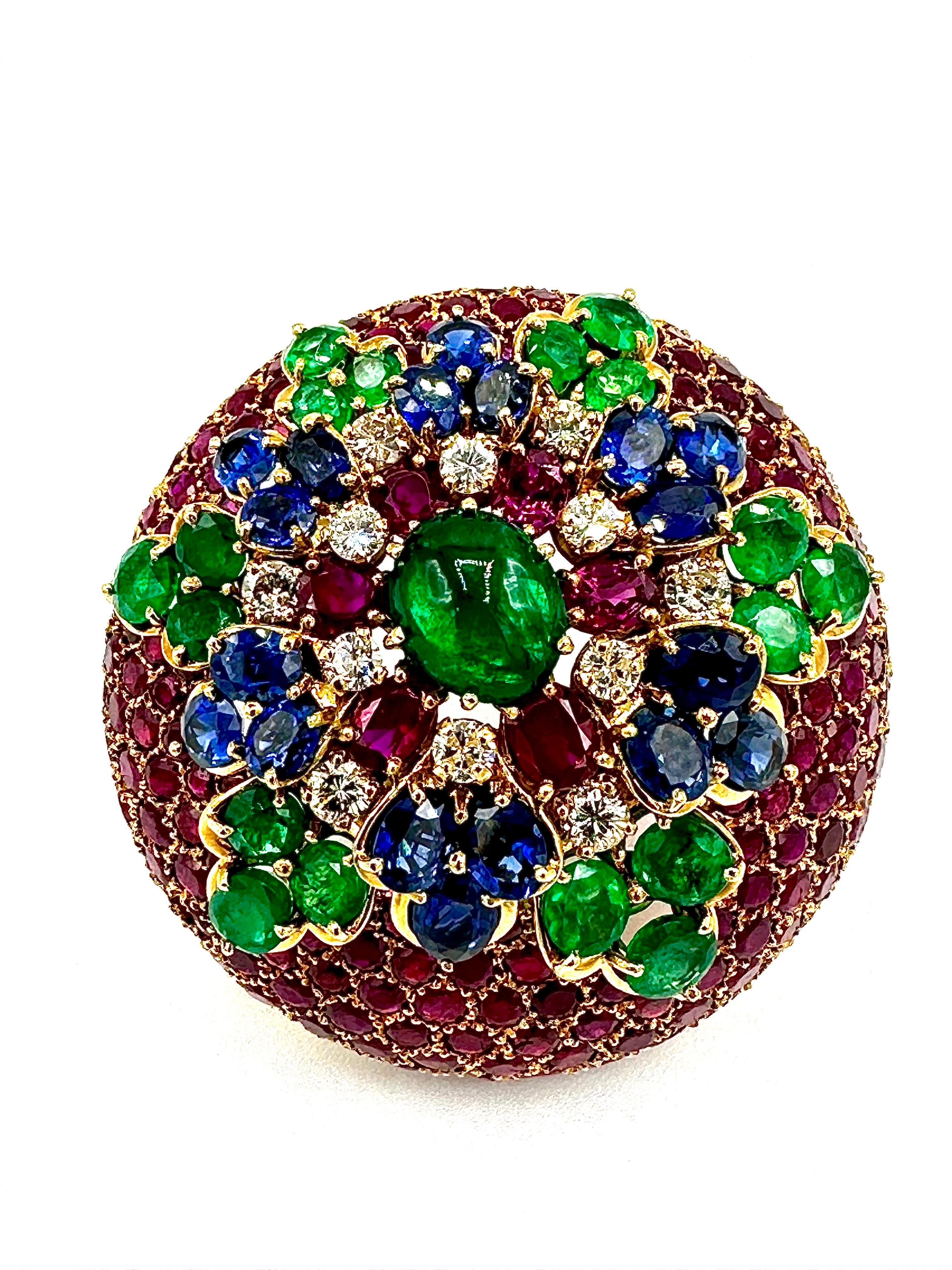 This brooch has an amazing array of colors!  The brooch contains over 35.00 carats in combination of all the Diamonds and Gemstones.  This is designed in a domed shape, with honeycomb shaped settings for the round Rubies, leading into a star pattern