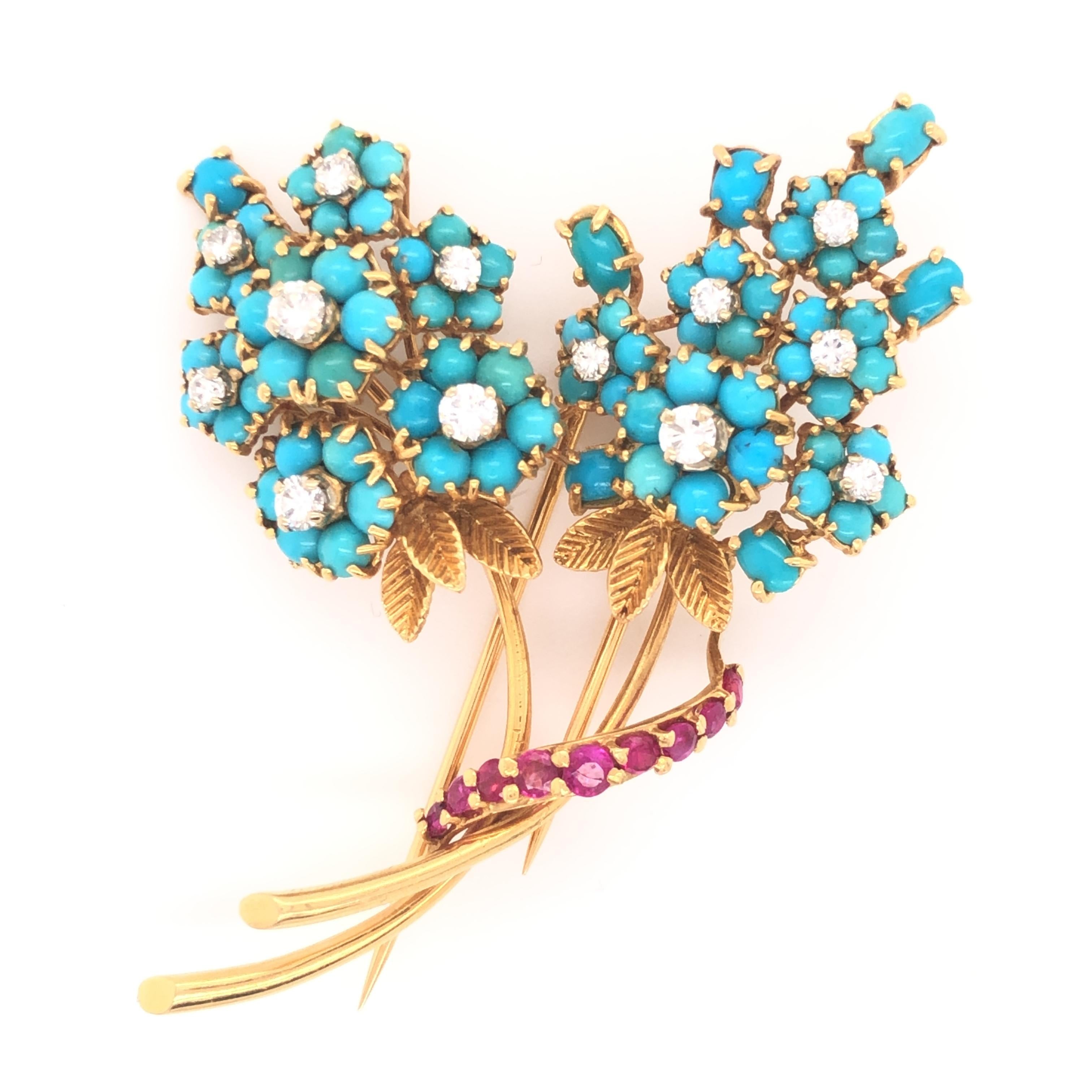 Gorgeous French made brooch crafted in 18k yellow gold. This fantastic piece depicts vibrant flowers set with cabochon set turquoise gemstones displaying natural colors. The blue color in the turquoise pops off the design making this piece sure to