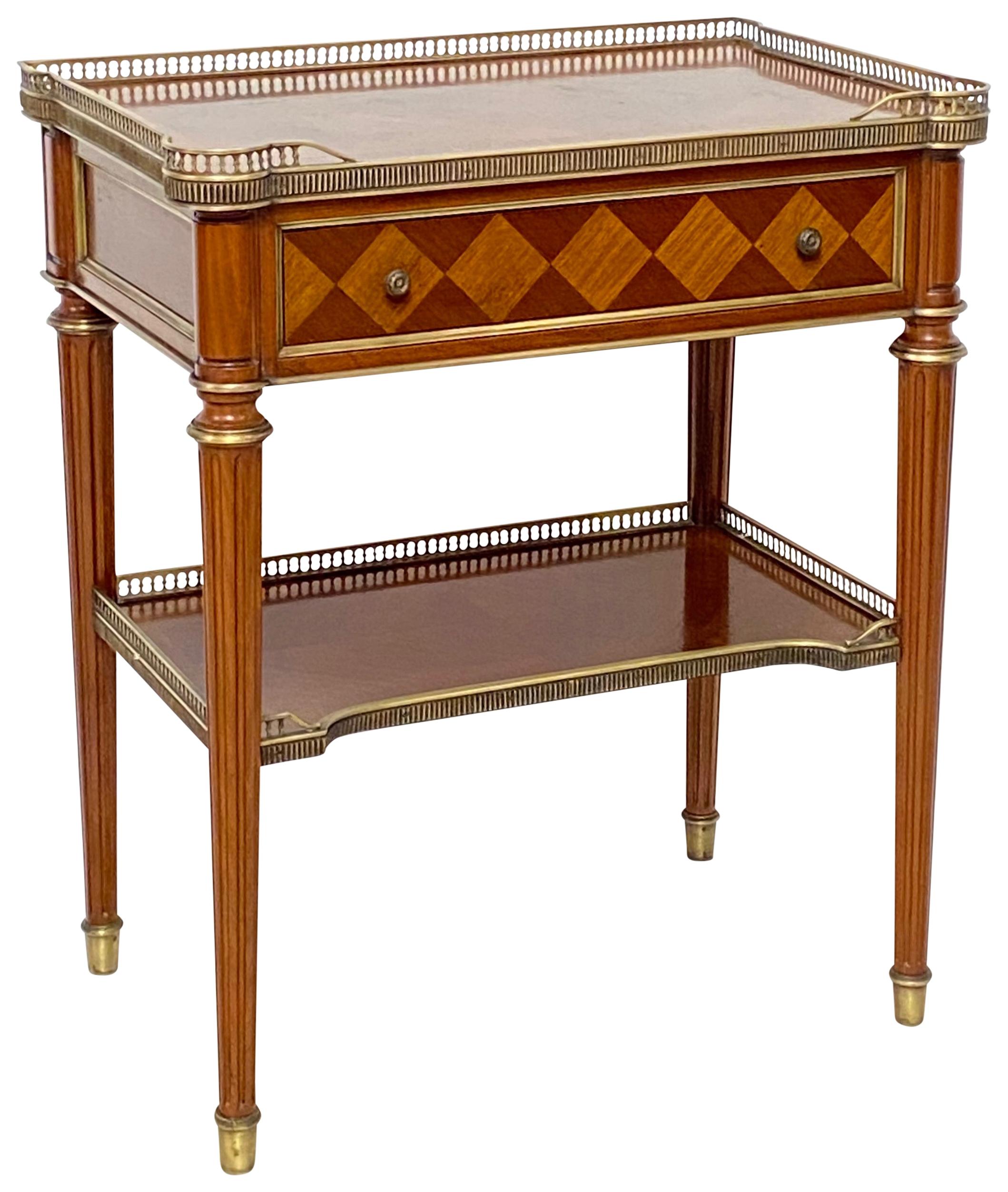 A fine quality beautifully made solid mahogany and book matched mahogany veneer low table, having a brass gallery, trim and hardware.
France, circa 1950.

 