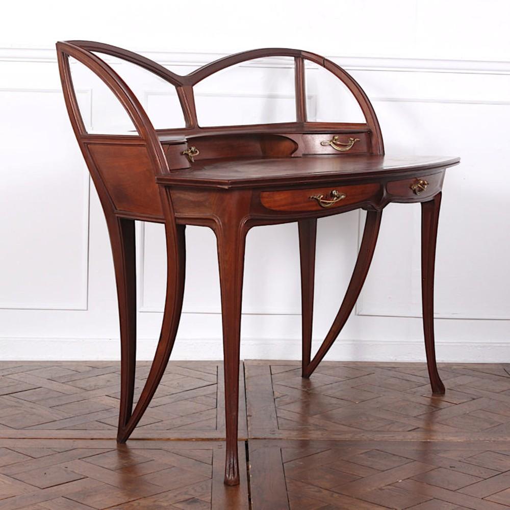 Signed ‘Louis Majorelle’ Art Nouveau desk with the sinuous lines and curves typical of the style. Four curved-front drawers retaining their original ormolu Art Nouveau pulls and with upper shaped glass back and sides. Signed on one of the drawers.
 