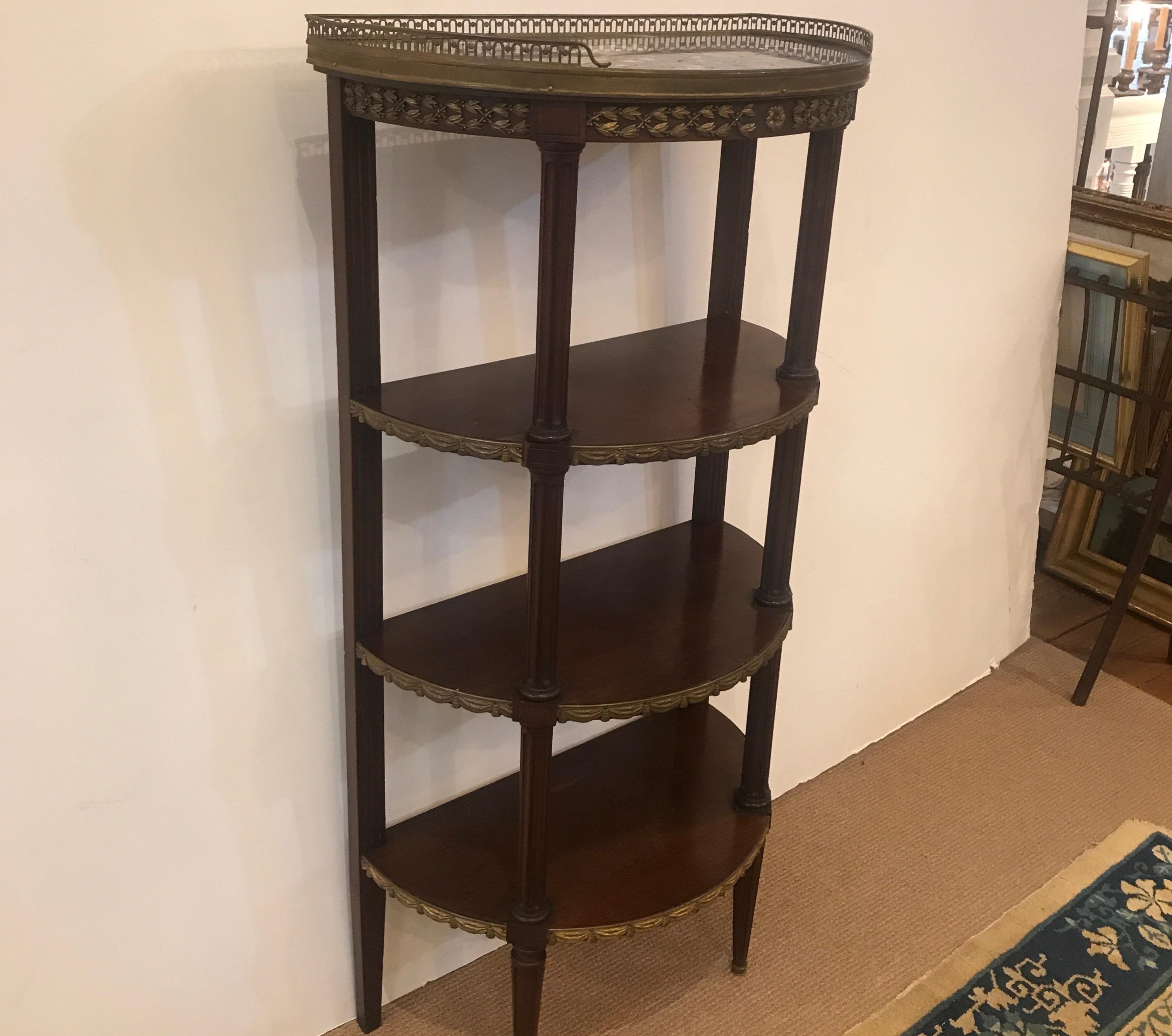 Antique French half moon étagère with gilt bronze mounts. 42 inches tall with original marble top with worn gilt bronze mounts, all original there is a line in the marble about one inch from one corner.