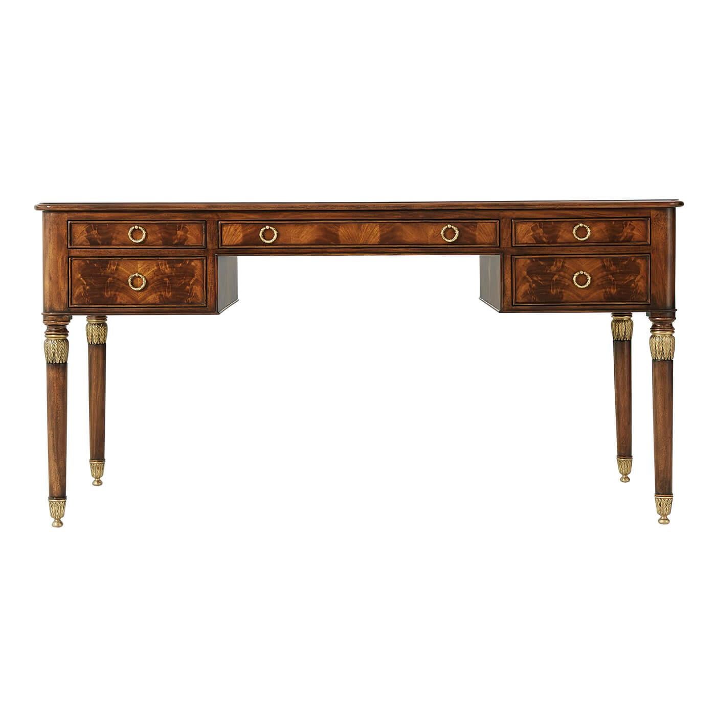 A flame mahogany writing desk, with leather inlaid side slides and five drawers surrounding the kneehole, on turned and brass leaf mounted tapering legs. The original Napoleon III.

Dimensions: 60