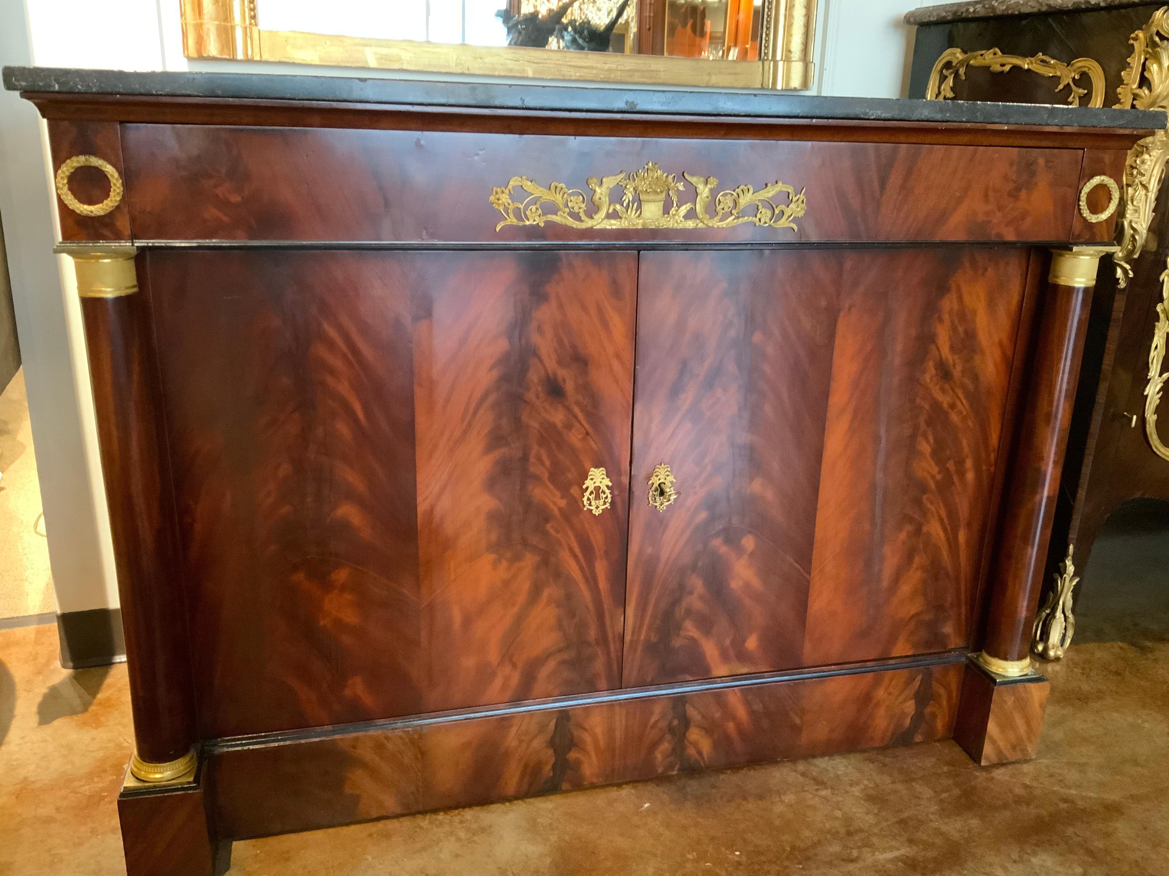 This cabinet is made of flame mahogany which makes it
Not only beautiful but strong and sturdy. It has a charcoal gray
Hue marble top. No breaks or restorations to the marble.
It has two doors that open to one shelf inside. It has one
Drawer