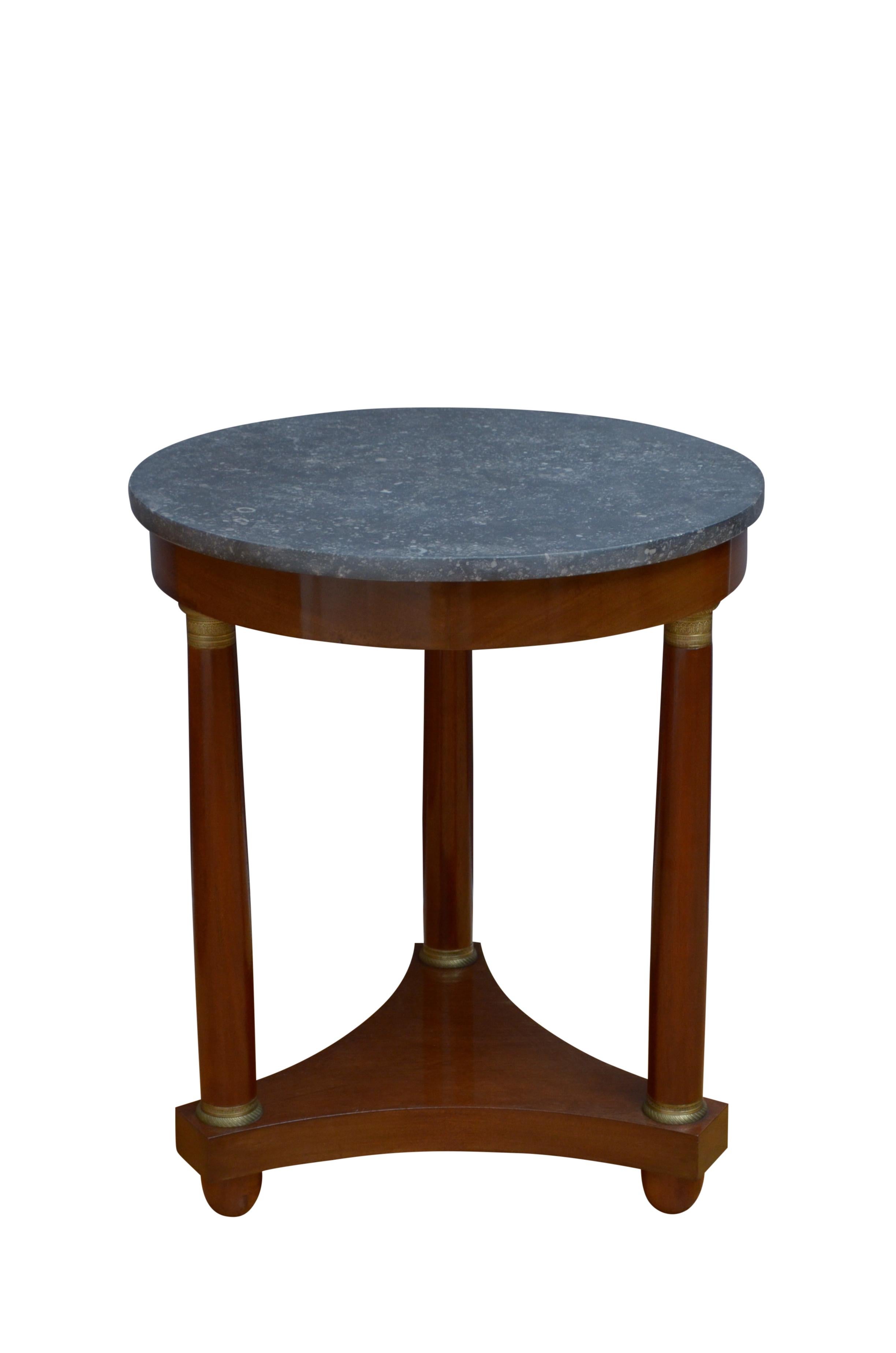 0226 Fine quality 19th century centre table of small proportions having original fossil marble top and shallow frieze, standing on three turned legs with fine brass capitols united by trefoil base terminating in original turned feet. This antique