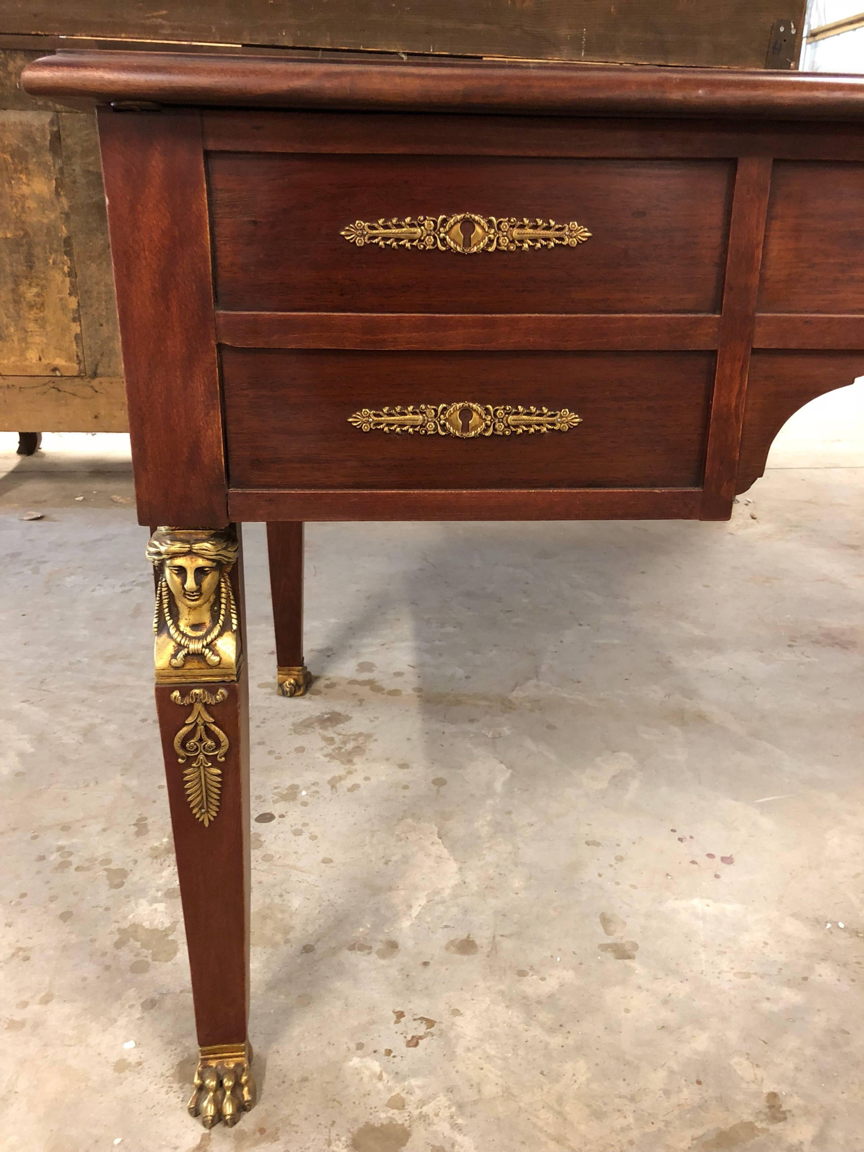 French neoclassic mahogany leather top bureau plat with double slides, brass ball sabots, bronze escutcheons and a fitted double drawer.