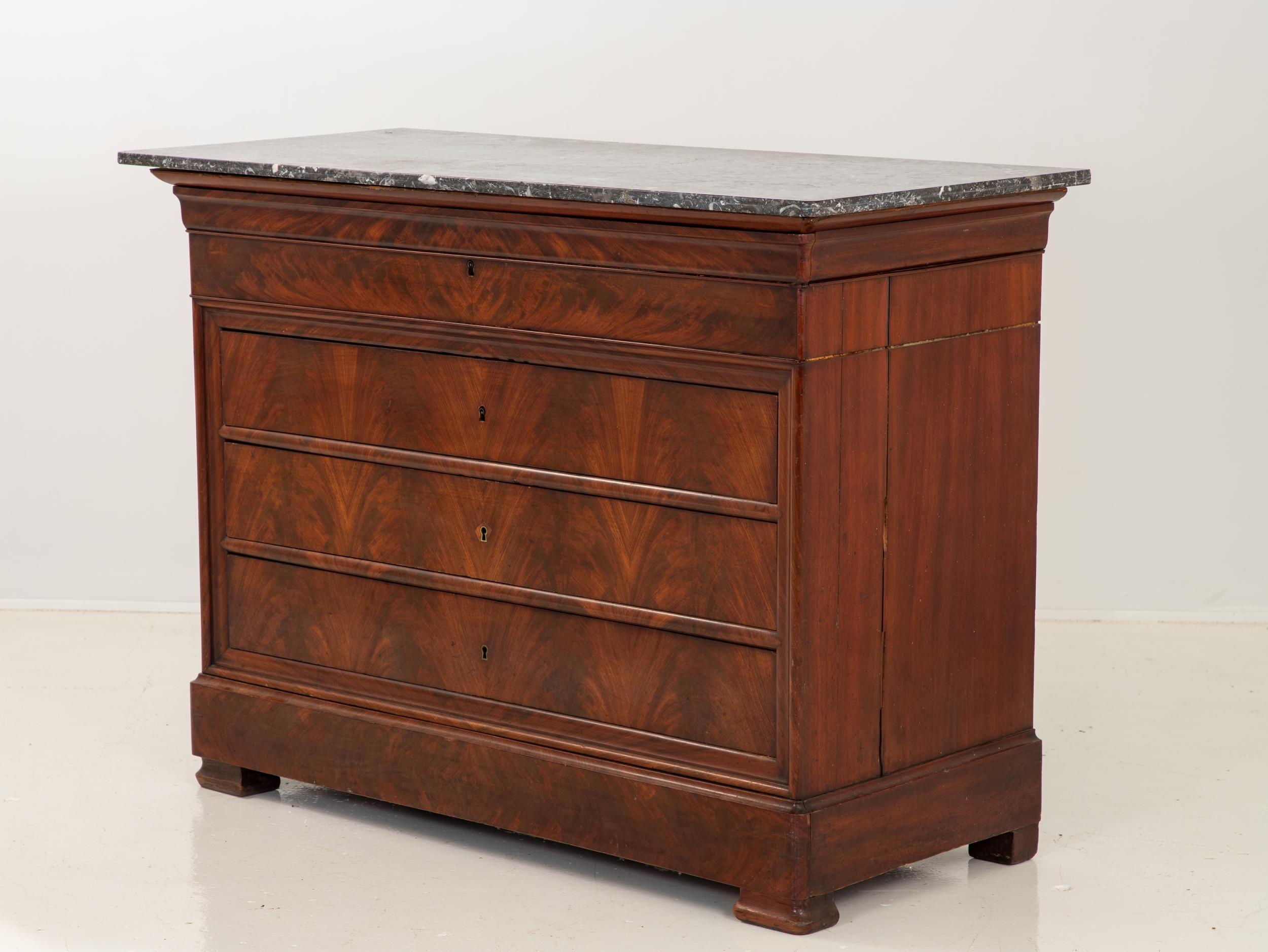 French late 19th century Louis Philippe secretary with a mahogany veneer. The top drawer front folds down and pulls out to reveal a leather writing surface, two drawers, and a pigeon hole. Splits in sides. Wear on leather surface. Repairs to veneer.