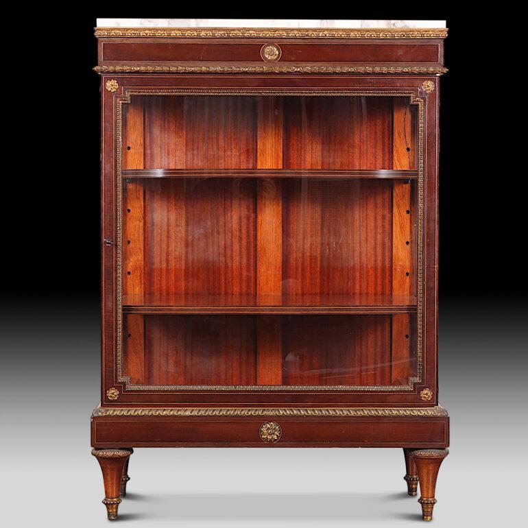 Lovely-Quality French inlaid Louis XVI style vitrine in mahogany with inlaid boxwood and ebony stringing, the case accented throughout with finely cast and finished gilt bronze mounts. Original marble top. C. 1890.

