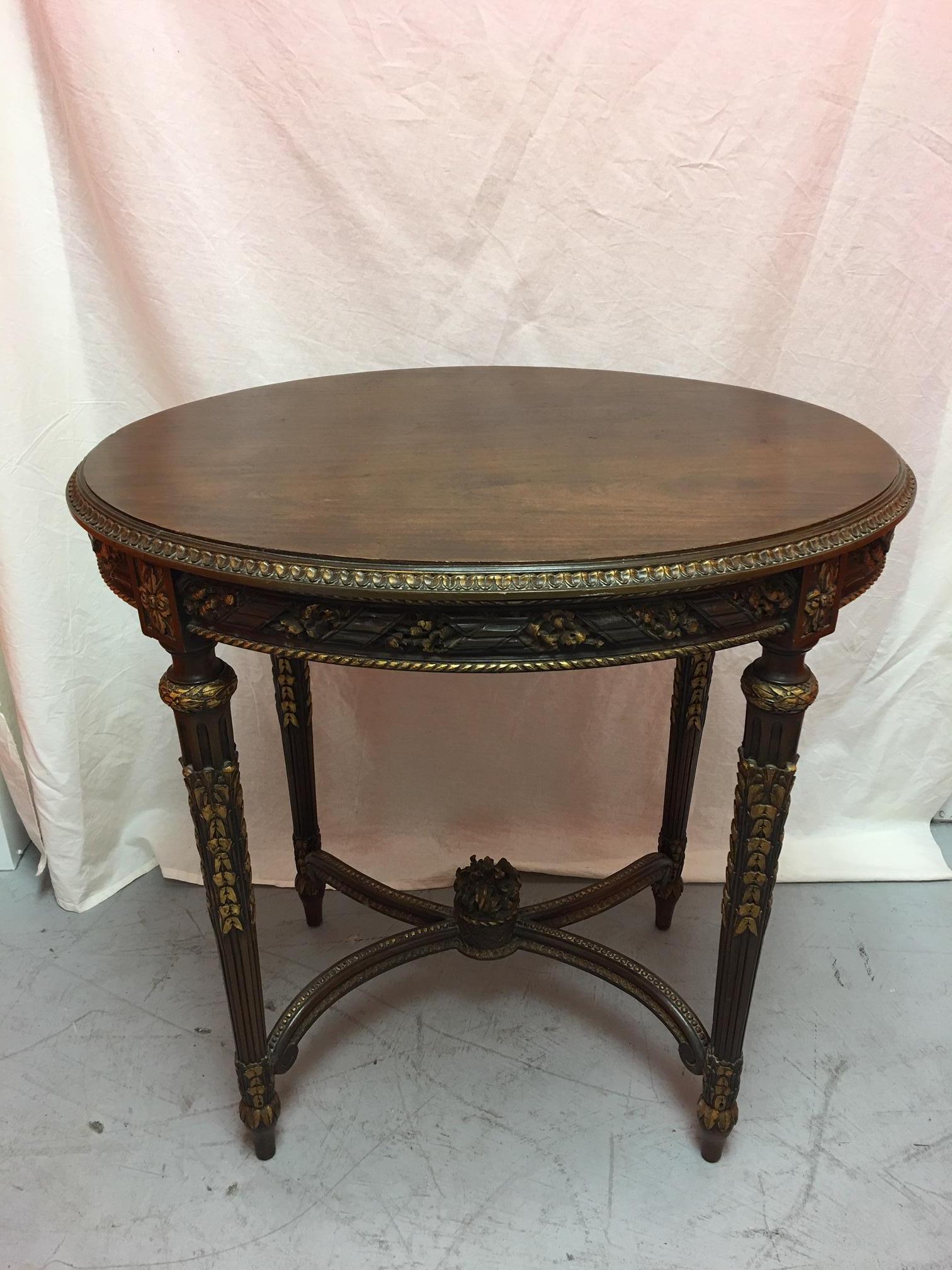 French mahogany oval table with gold painted ormolu, early 20th century.