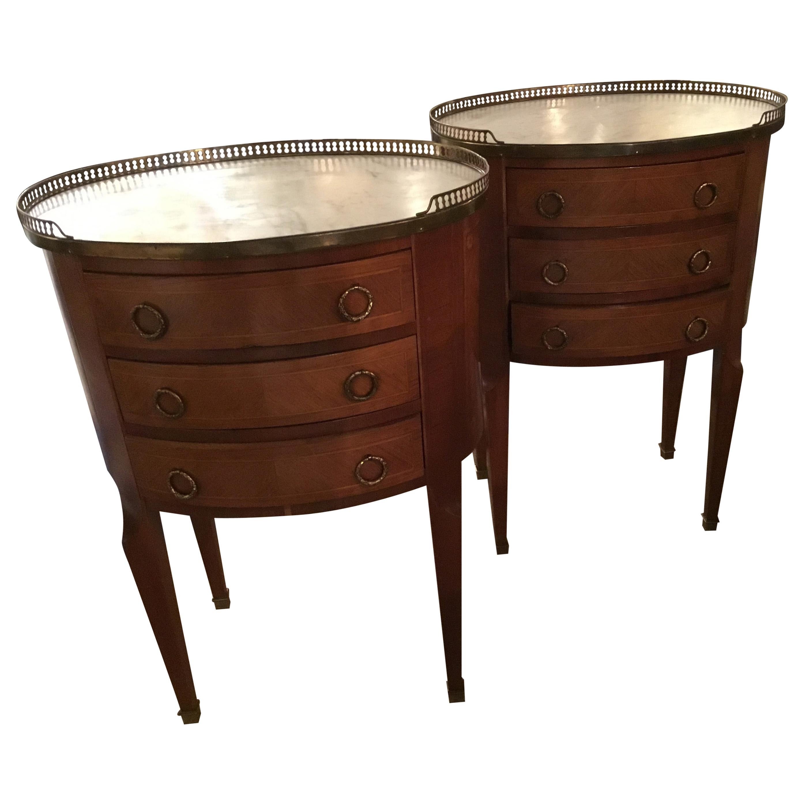 French Mahogany pair of occasional tables in oval form with marble tops