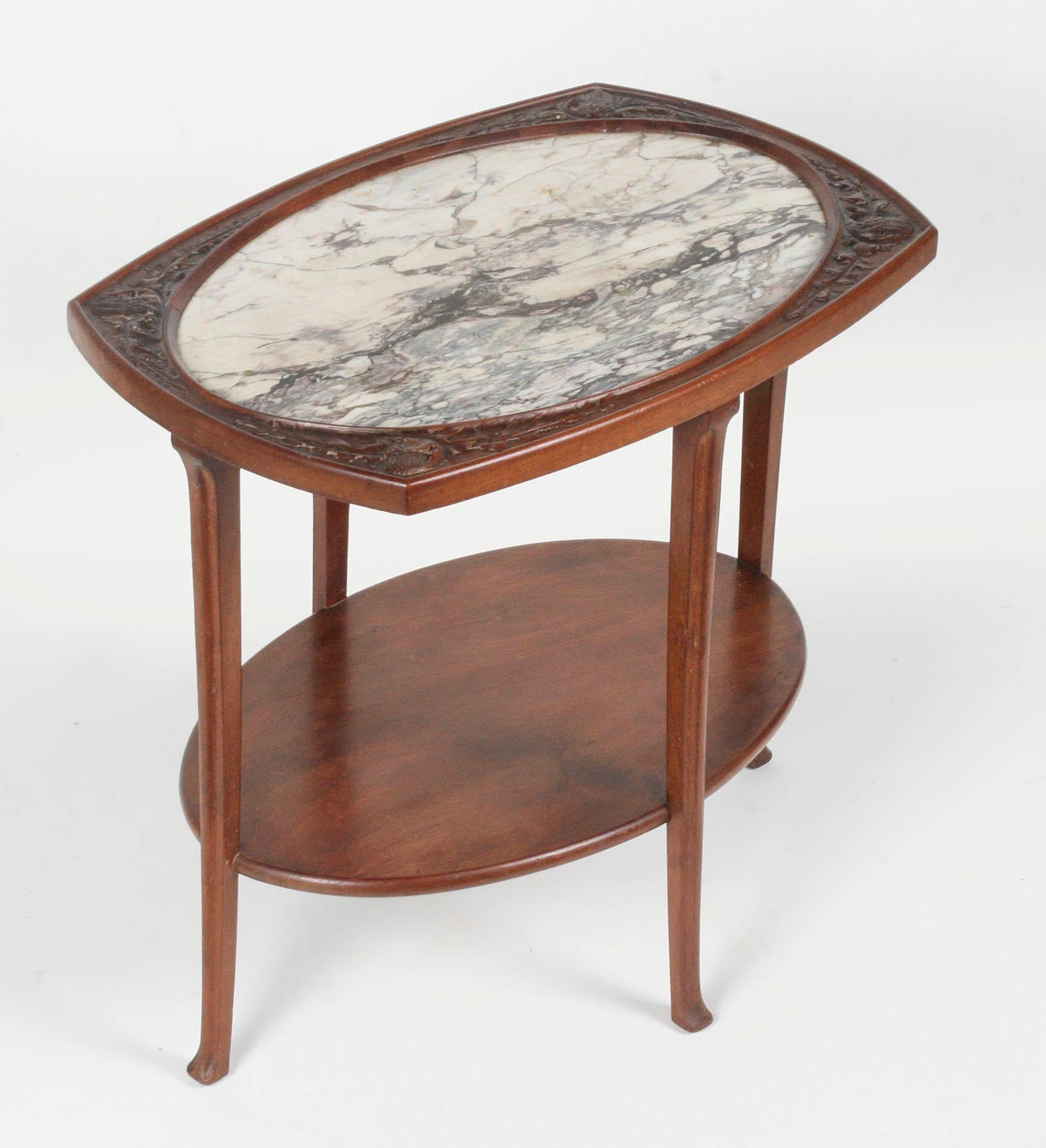 Elegant Art Nouveau side table with carved edges and marble top in the middle. The type of marble is Brescia violet.
The table was made in France, circa 1910. Typical Art Nouveau characteristics of this table are the elegantly shaped legs and the