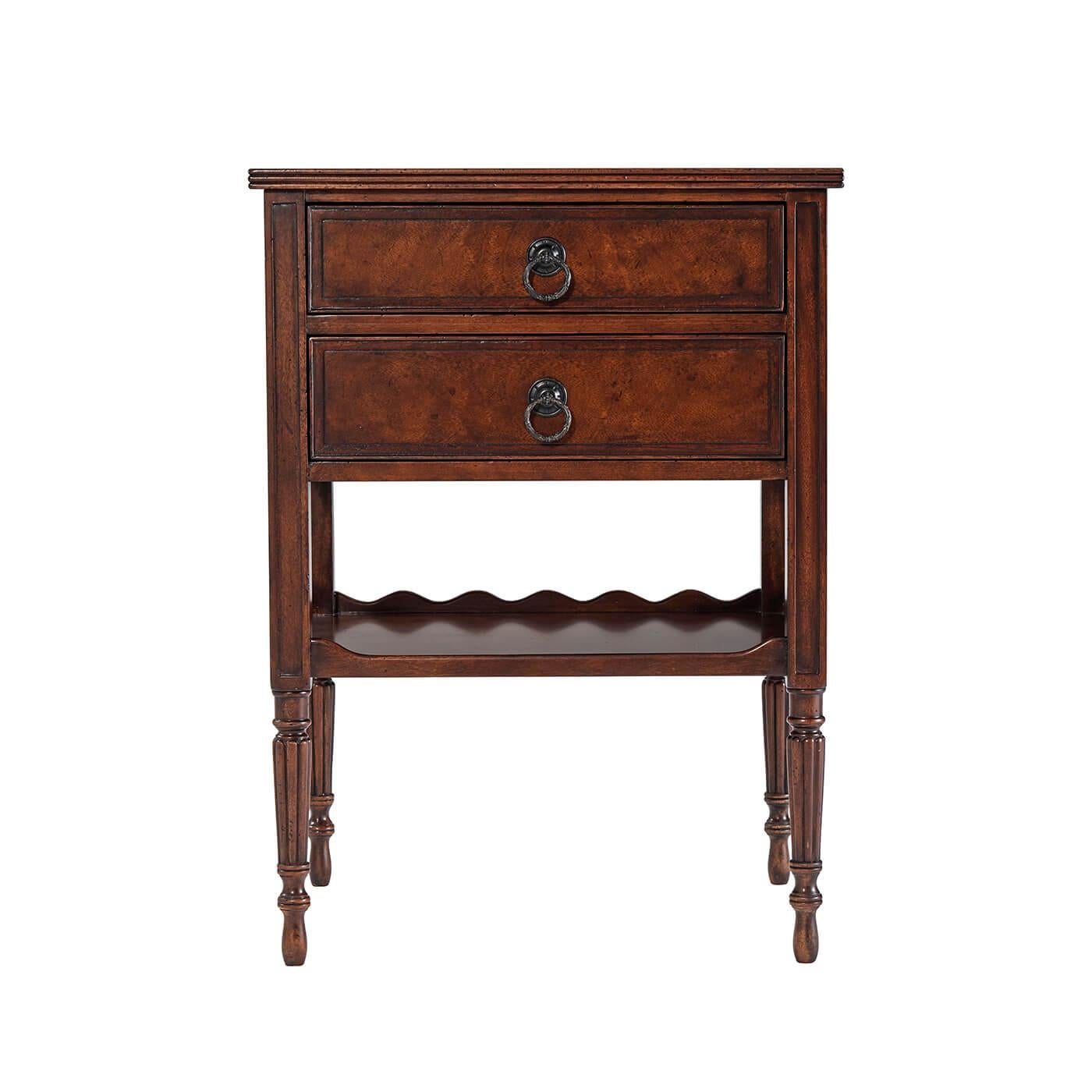 A French Louis XVI Provincial nightstand, the rectangular crossbanded and reeded edge top above two graduated drawers and a serpentine three-quarter galleried under tier, on turned and reeded tapering legs with skittle feet. 

Dimensions: 22