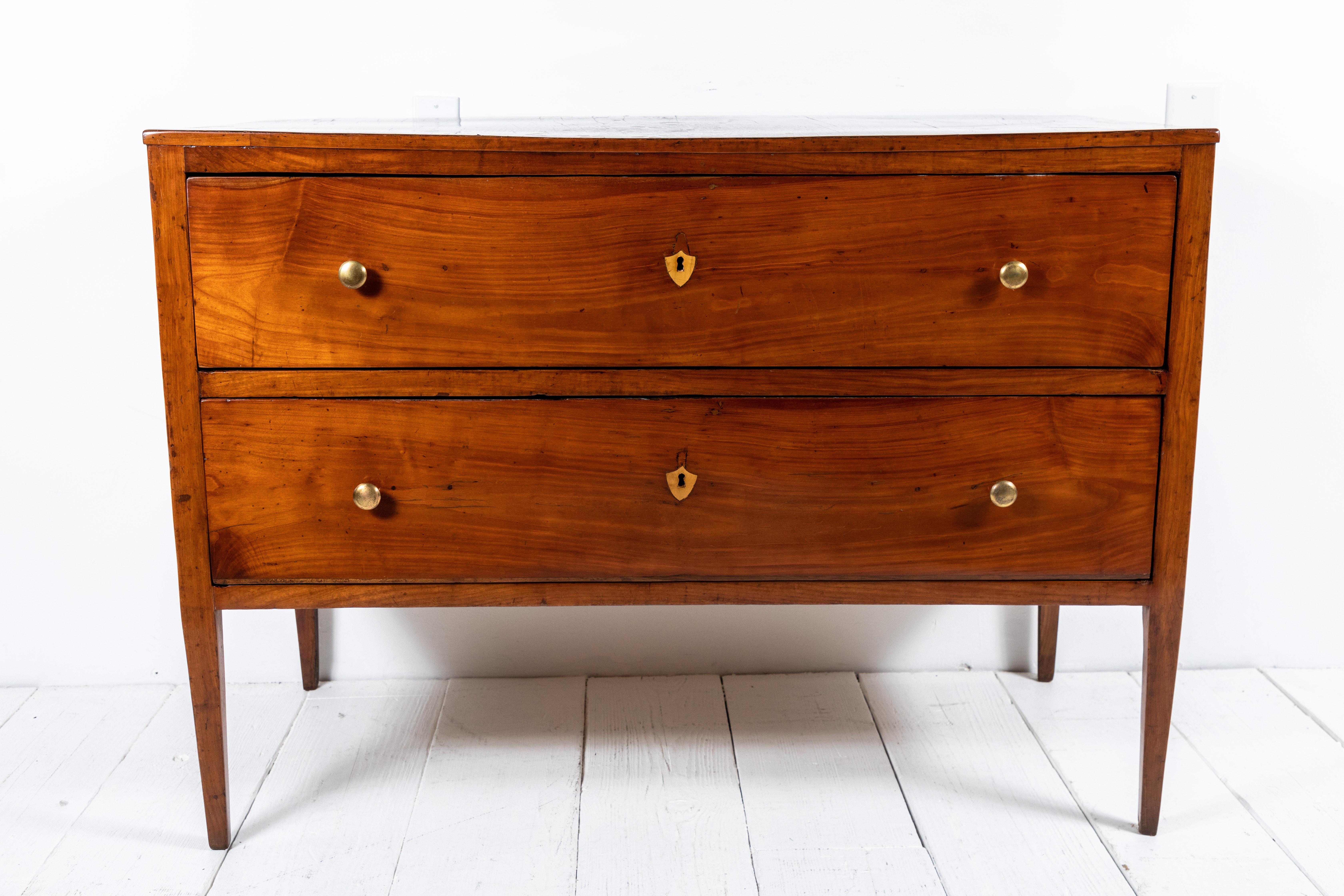 Classic French mahogany two-drawer commode stands tall on four tapped legs. Aged with patina original key holes and hardware. The Commode is grand in appearance.