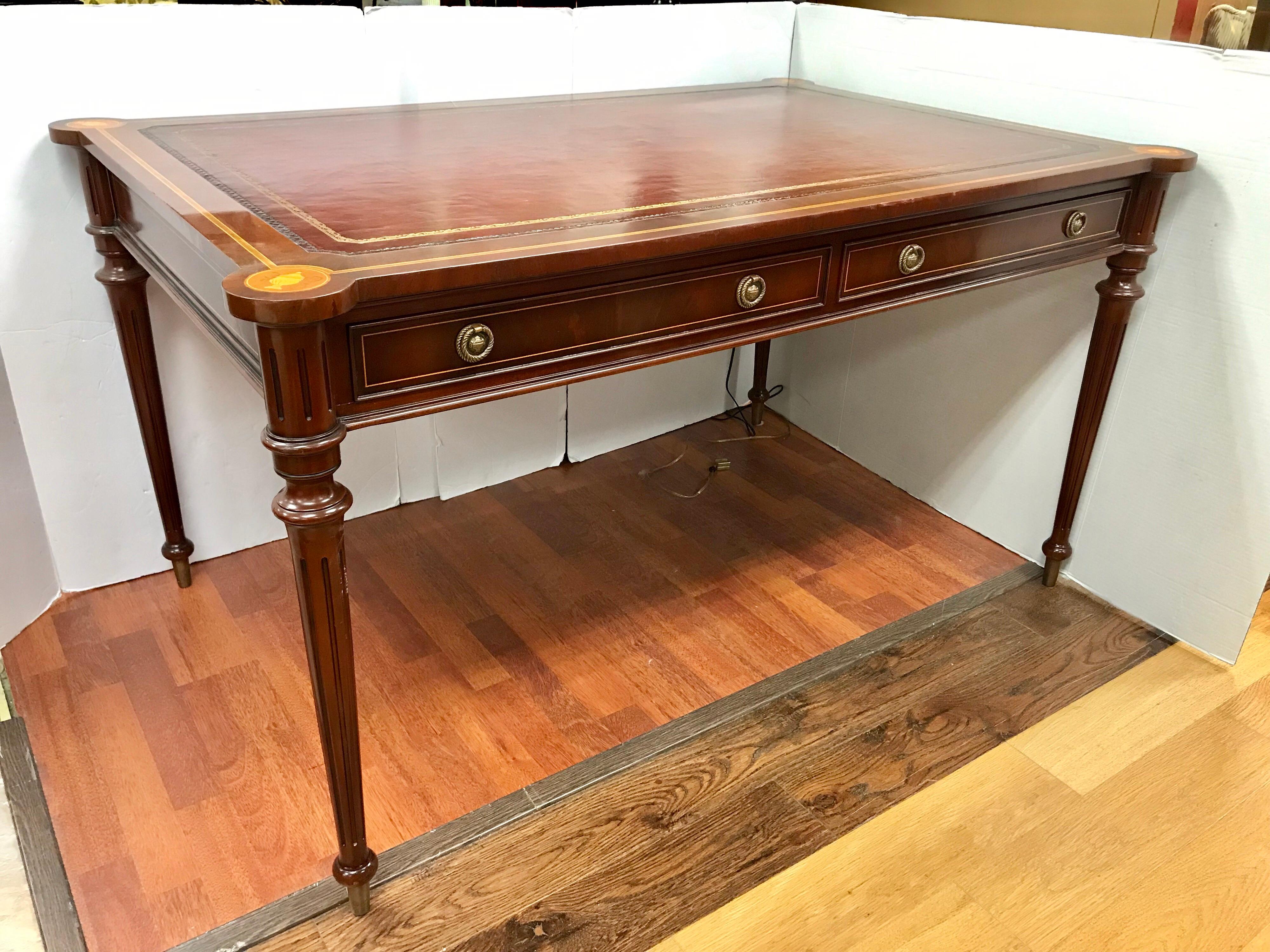 Magnificent mahogany writing desk with leather top and inlay and medallions.
Two drawers at top. Exceptional design and condition.
