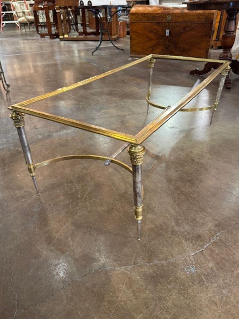 Vintage French Maisin Jensen manner silver and gilt brass coffee table. A glamorous fusion of metallic finishes and sculptural elegance—silver and gilt brass coffee tables in the manner of Jensen offer bold geometry, rich textures, and timeless