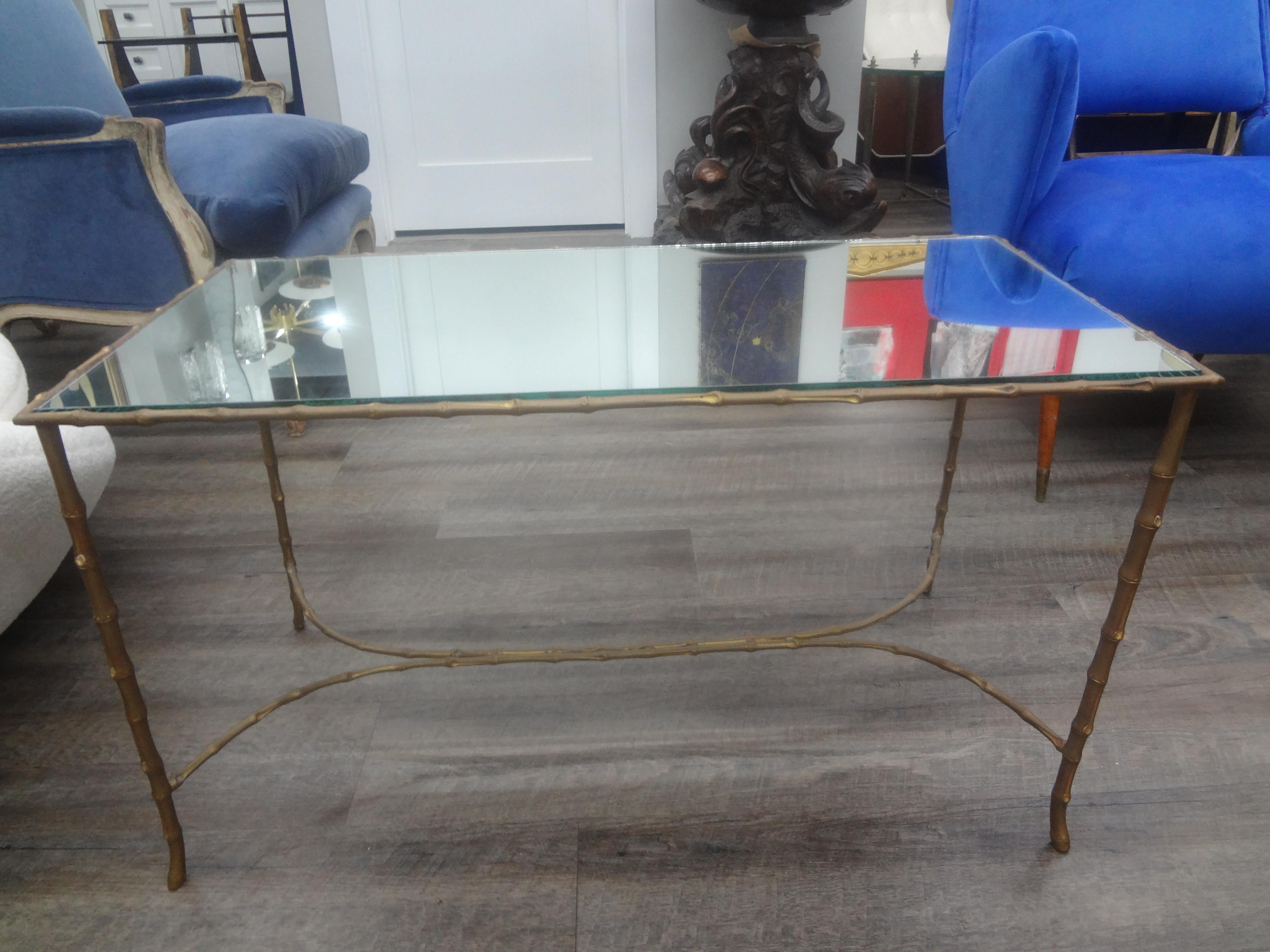French Maison Baguès Bronze And Mirror Coffee Table.
This elegant French Maison Bagues attributed Louis XVI style faux bamboo bronze cocktail table with graceful legs and a mirrored top dates to the 1940's.
Beautifully aged patina to the