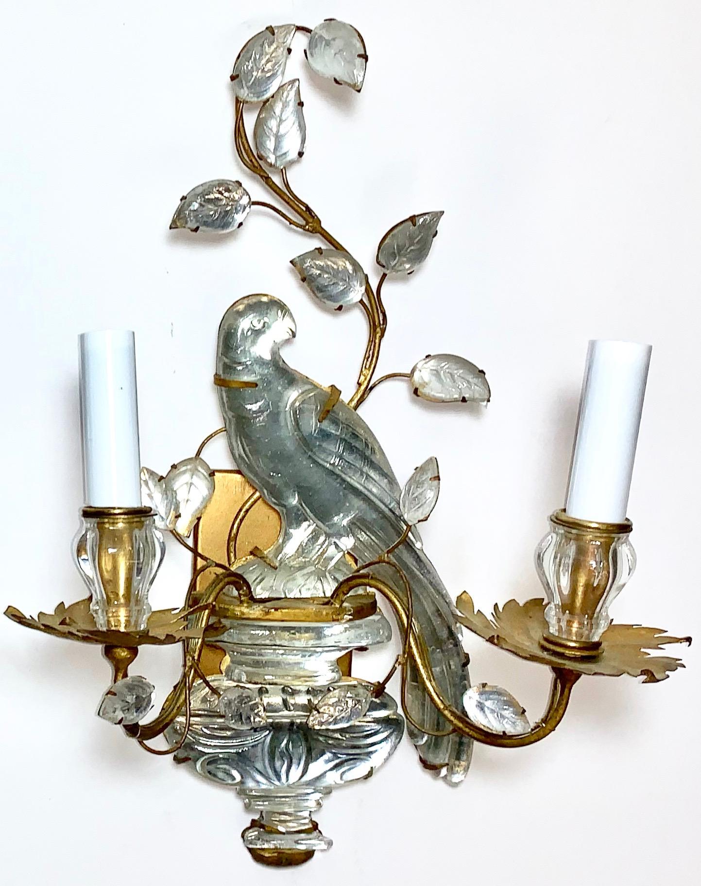 French pair of Art Deco period sconces made by Maison Baguès with crystal birds and foliage. The pair is in great vintage condition with some minor age-appropriate wear to the metal.