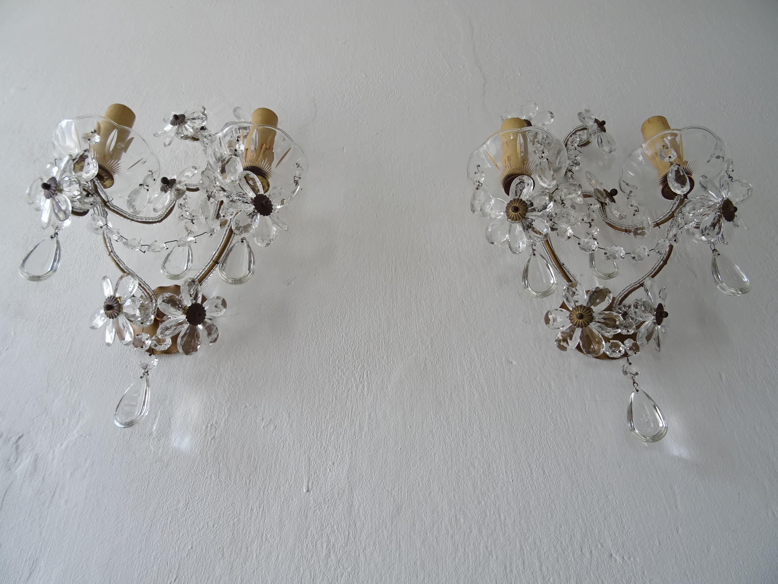 Housing two lights each, (will be newly rewired with certified UL US sockets for the USA and appropriate sockets for all other countries and ready to hang). sitting in crystal bobeches dripping with vintage crystal prisms. Double beading throughout.