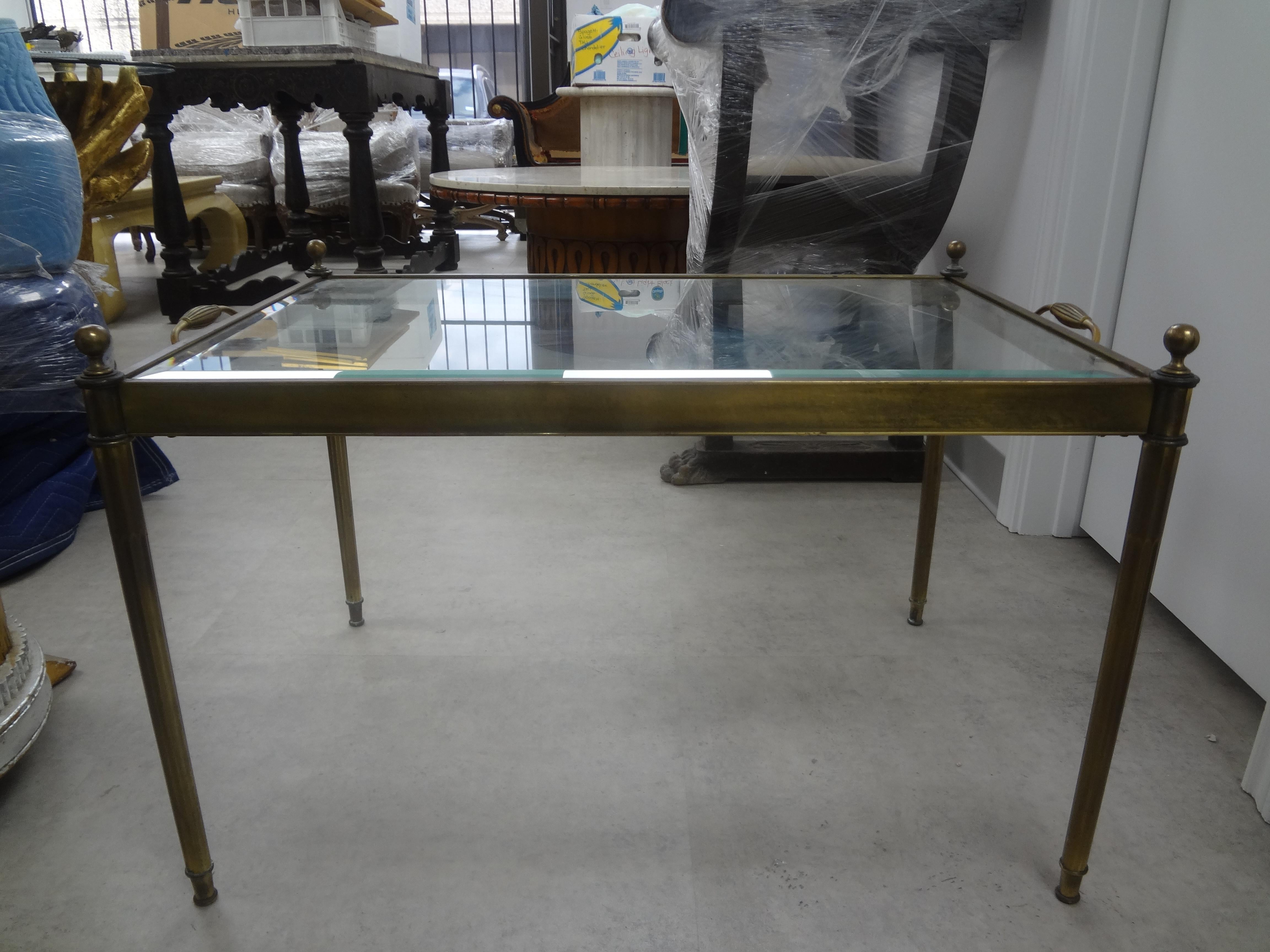 French Maison Bagues inspired Louis XVI style brass and glass coffee table.
Unusual French on Mansion Bagues inspired Louis XVI style brass coffee table with a beveled glass top. This gorgeous French cocktail table or side table has tray like