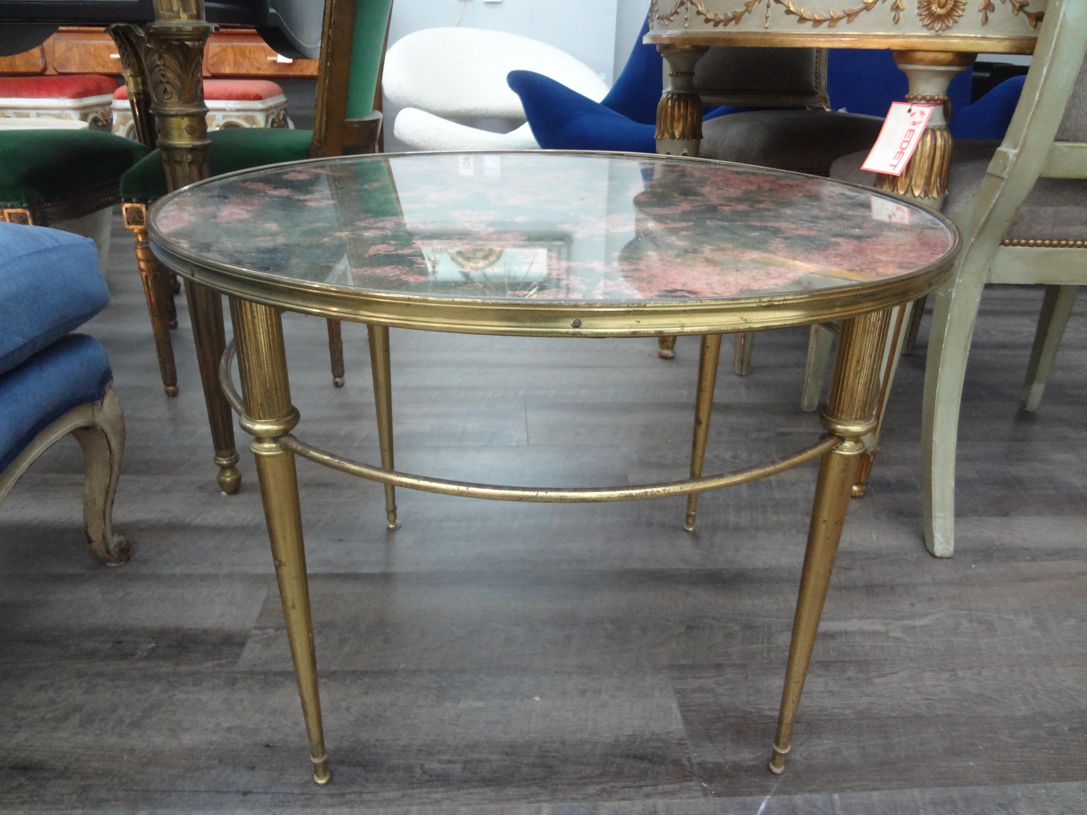 French Maison Bagues Louis XVI Style Cocktail Table
This stunning round French Baguès style coffee table or cocktail table has the most unusual eglomise glass top. This French Louis XVI style table could also be used as a side table or tea