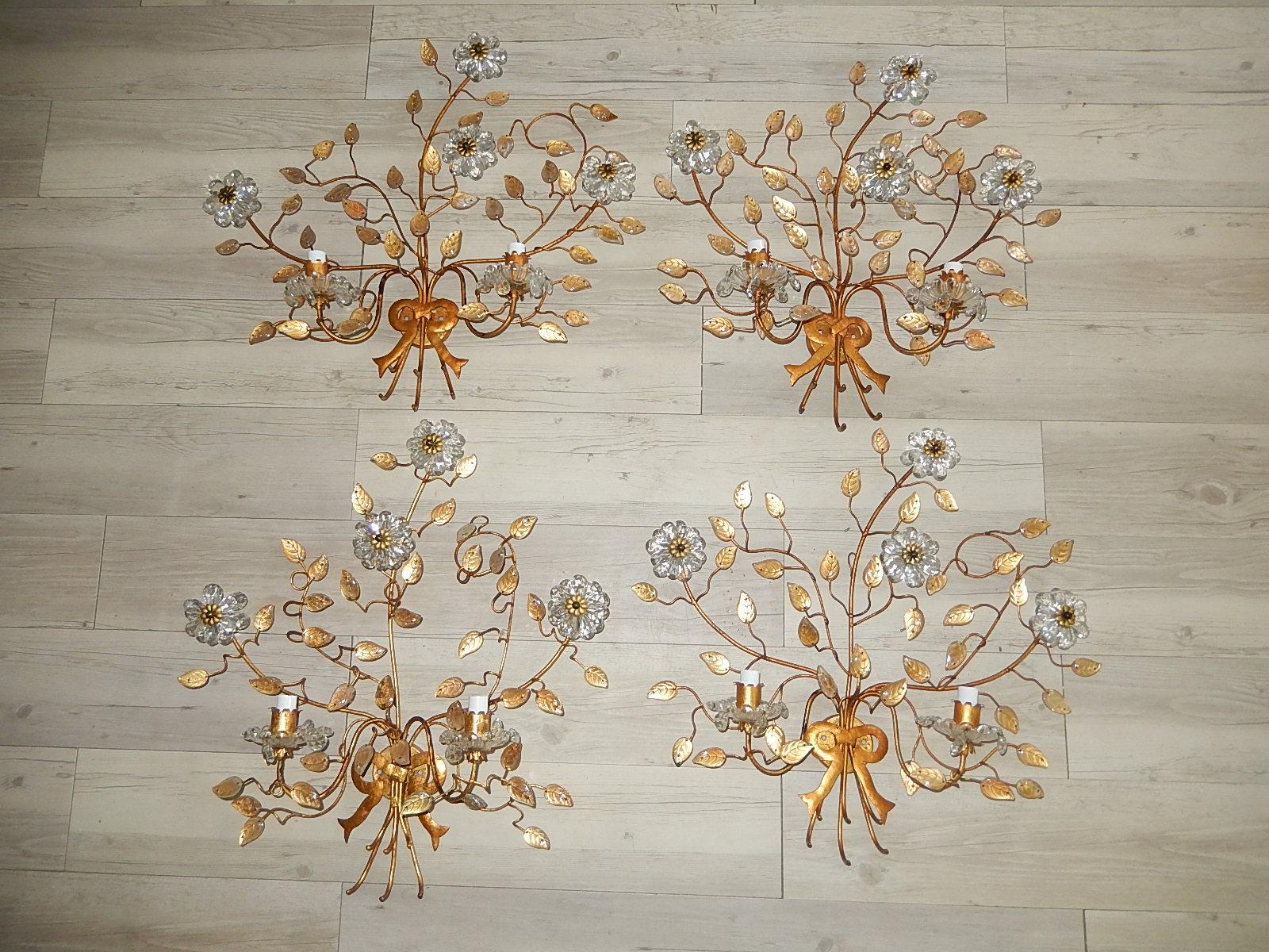 Four Maison Baguès double arm sconces. Rewired and ready to hang. Adorning 4 flowers on each made up of crystal prisms. Crystal bobèche with crystal prisms as well. Glass leaves throughout. Big gold bow on bottom. Free priority shipping from Italy.