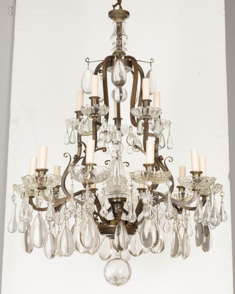 A French Art Deco Period Maison Bagues style large chandelier with brass frame and two tiers of candles, five on the top and ten on the bottom, with a light in the center of the spear. Rewired with new sockets. Original crystals including smooth