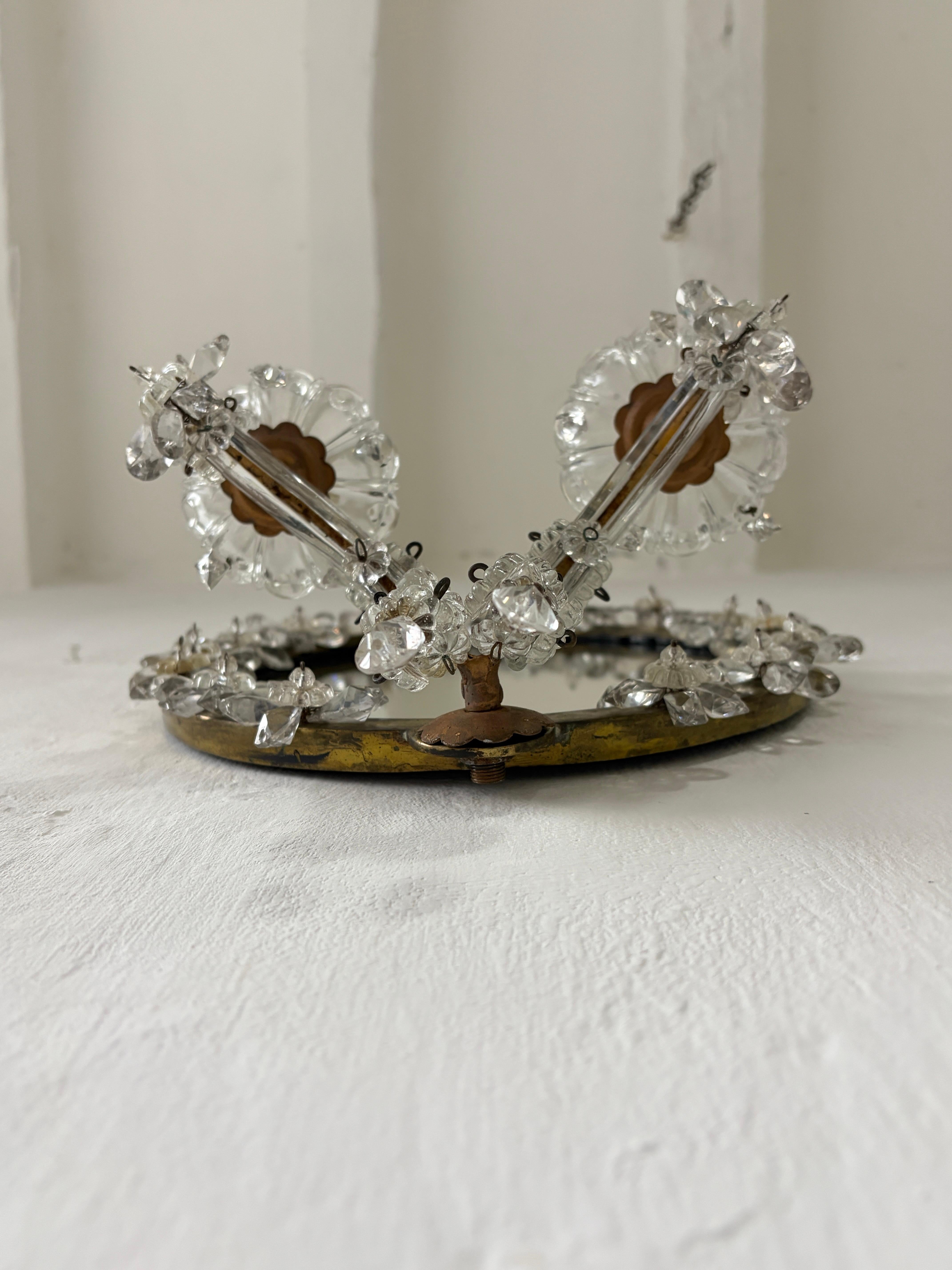 Housing 2 lights each, sitting in crystal bobeches dripping with crystals. These will be rewired with certified UL US sockets for the USA and appropriate sockets for every other country and ready to hang. Amazing one of a kind set.  Bronze body that