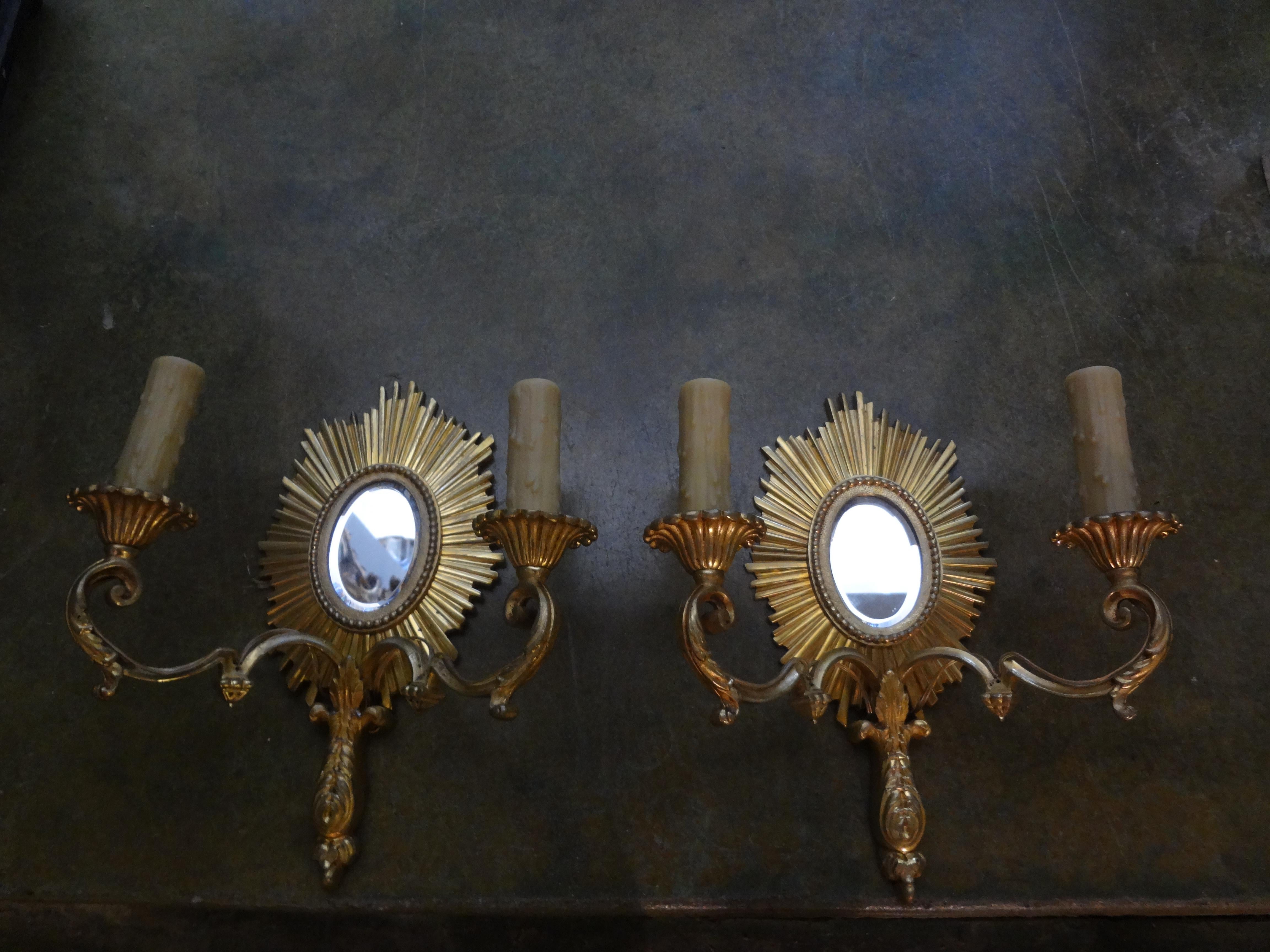 French Maison Baguès attributed gilt bronze sunburst sconces.
Stunning French Maison Bagues attributed gilt bronze 2-light sunburst sconces. These fabulous French Maison Baguès bronze sconces have a beautiful sunburst design with a beveled mirror in