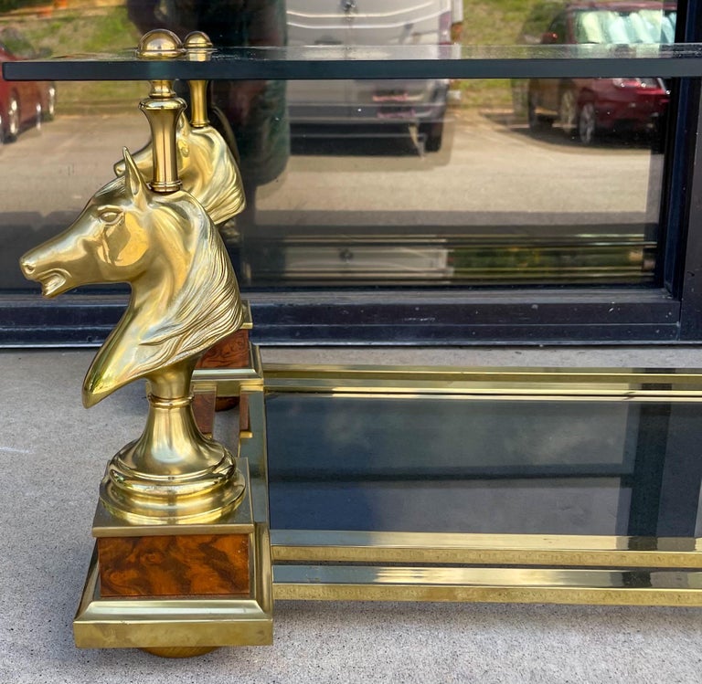 This is a special statement piece! Purchased in Paris, it is a neo-classical style brass and faux burl coffee table by Maison Charles. It is the Cheval table represented by four horse head form corners with faux burl bases. Both pieces of banded