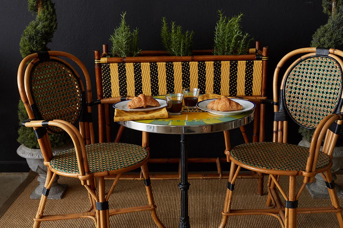 Whimsical French bamboo rattan jardinière planter by Maison Gatti. Constructed from a rattan frame and decorative woven resin black and yellow stripes. The resin caning is made from castor oil plants, not plastic. Made by Parisian artisans since