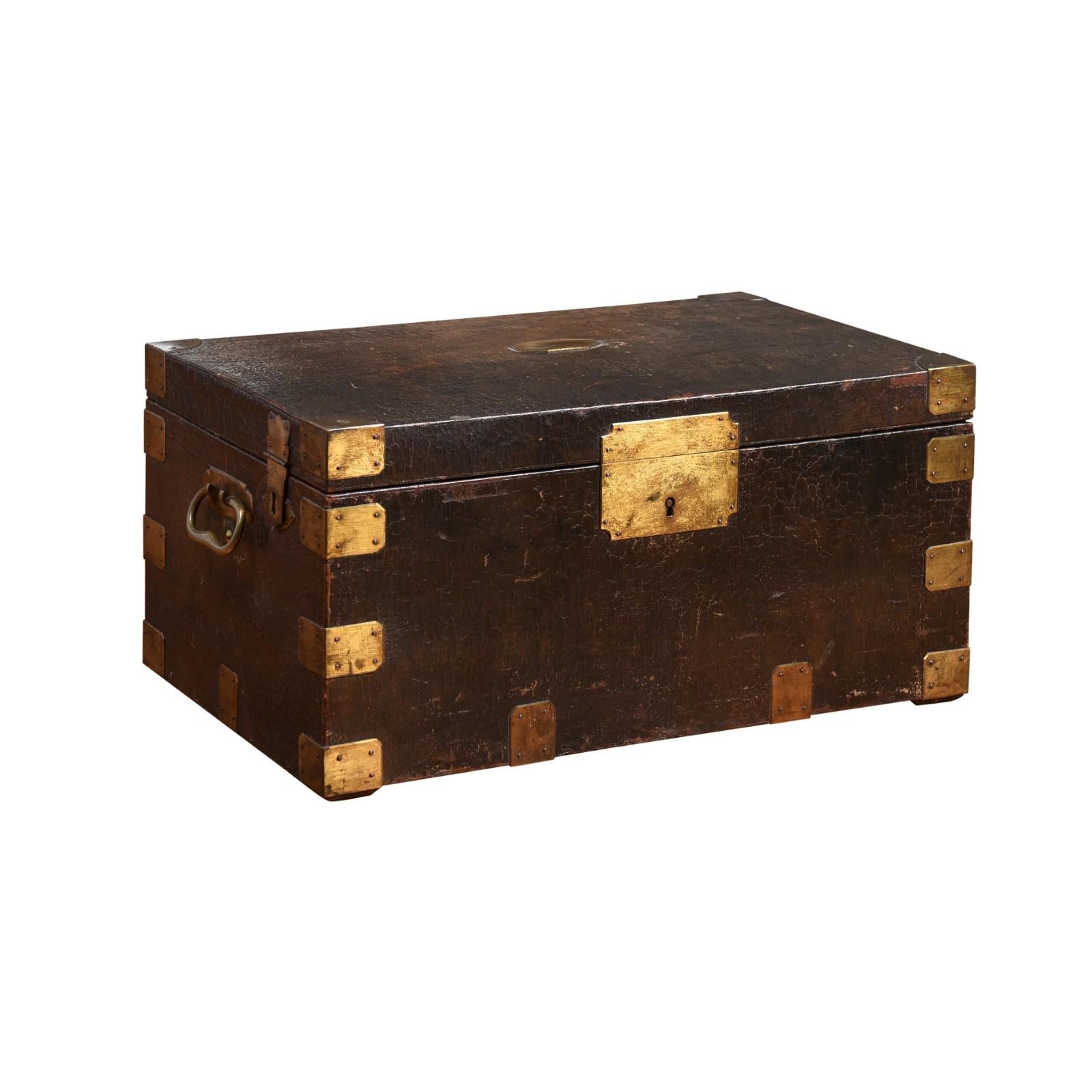 A French wooden decorative box from the 19th century from the Maison 'Gellée Gainier' à la Boule d'Or, Paris, leather bound with brass braces, presenting a compartmented interior and brass lateral handles. Created on the Île de la Cité close to the