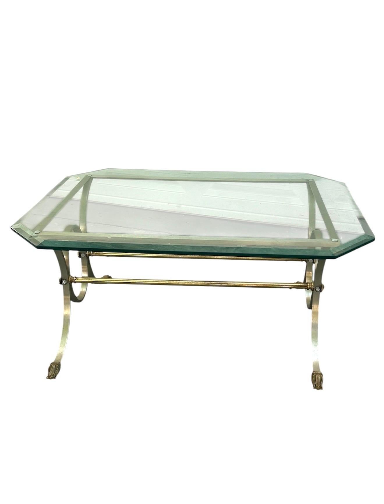 French Maison Jansen attr. Octagon Glass Neoclassical Style Coffee Table

Elegant vintage Neoclassical style coffee table with glass, polished brass
and steel construction. The octagon glass top has beveled edges. This mid
20th century table