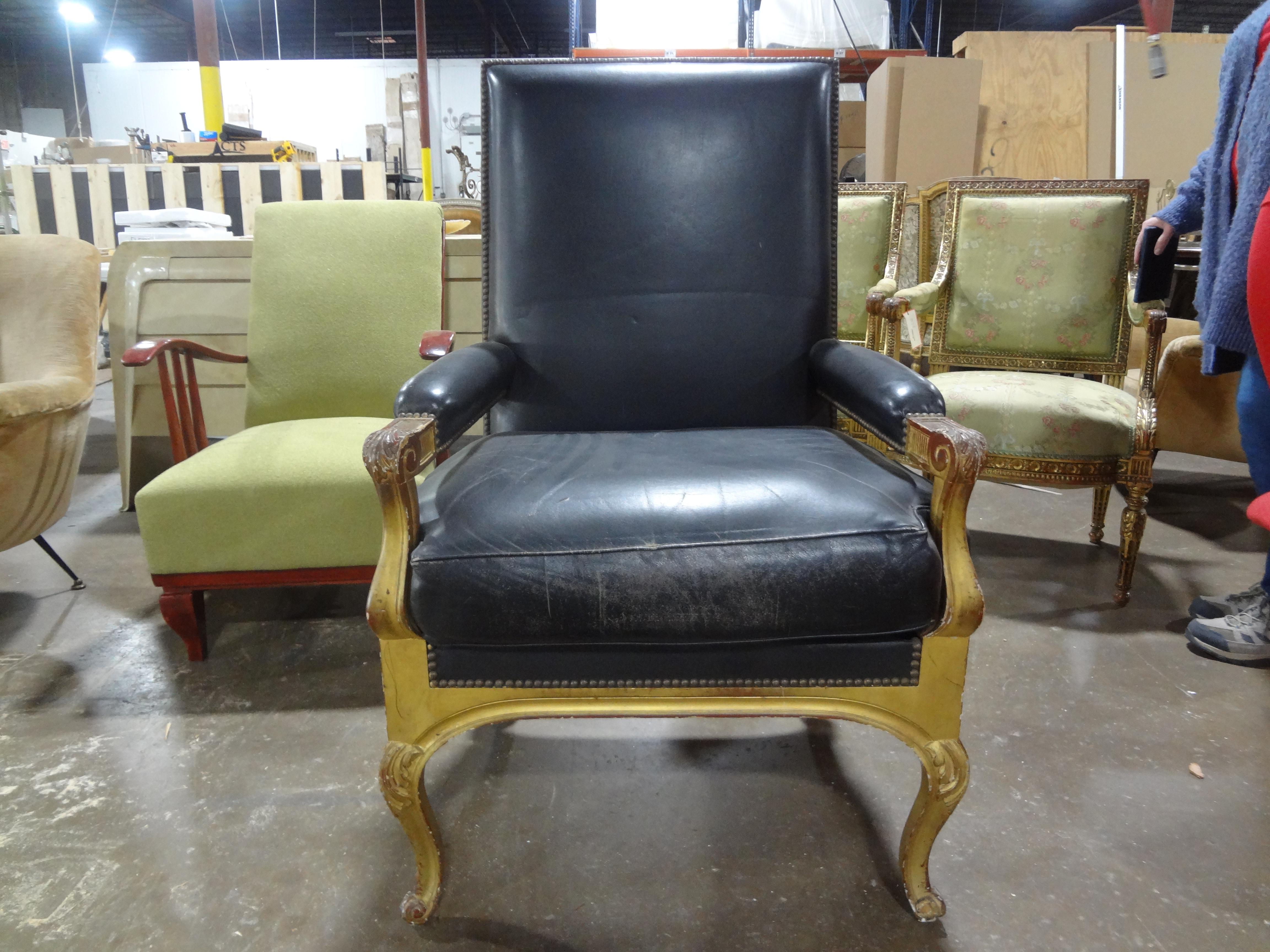 French Maison Jansen Louis XVI Style Giltwood Fauteuil.
Our handsome large French Louis XVI style gilt wood fauteuil or arm chair is upholstered in distressed black leather and is the perfect side chair or desk chair.  Great chair for a large