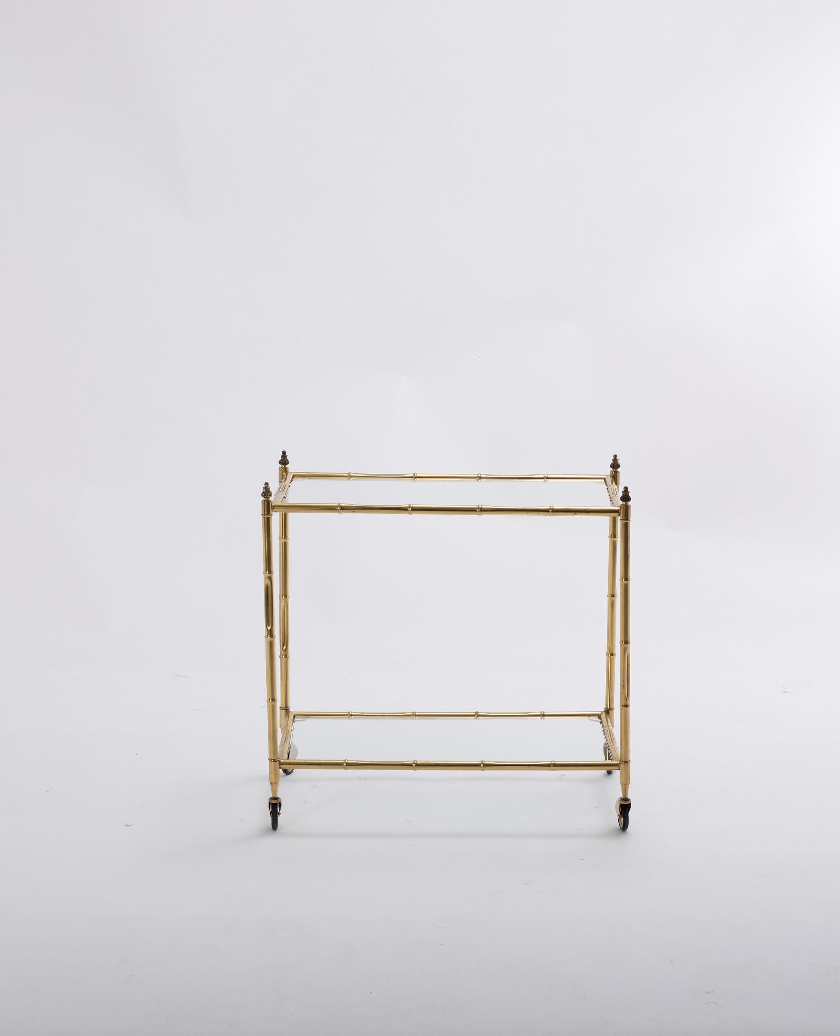 Vintage 1940s Jansen style brass bar cart with two glass shelves.