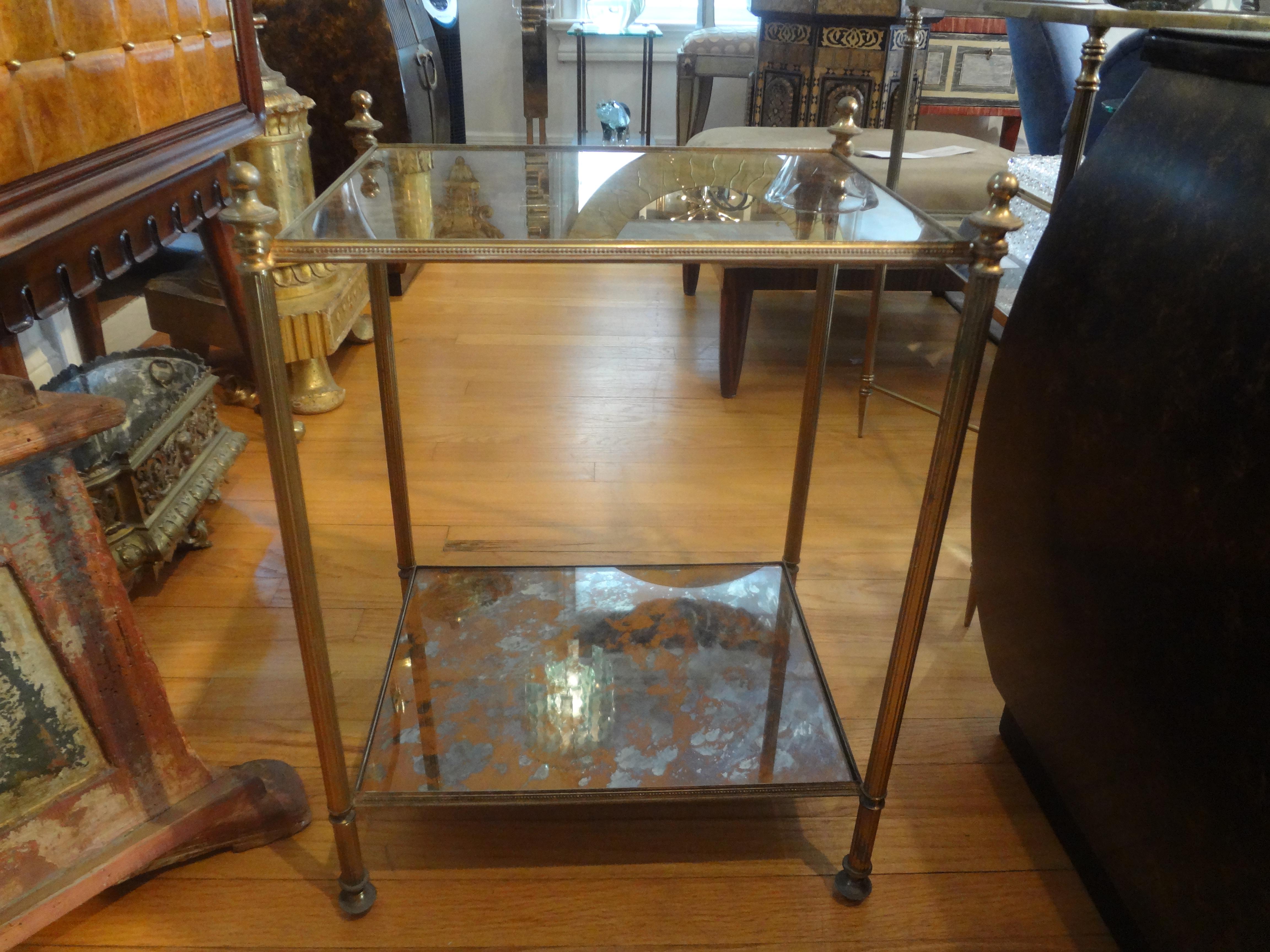 French Maison Jansen style bronze and mirrored table.
Stunning French Maison Jansen Louis XVI style bronze side table, drink table or gueridon with marbleized mirrored top. 
This versatile table can be used in a variety of spaces and easily moved