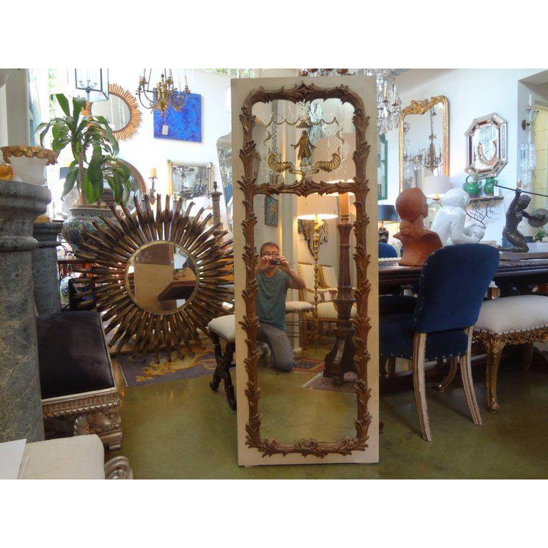 Unusual French Maison Jansen style chinoiserie églomisé mirror, circa 1920. This vertical French trumeau mirror, hall mirror or full-length mirror is painted a cream color with gilt accents.