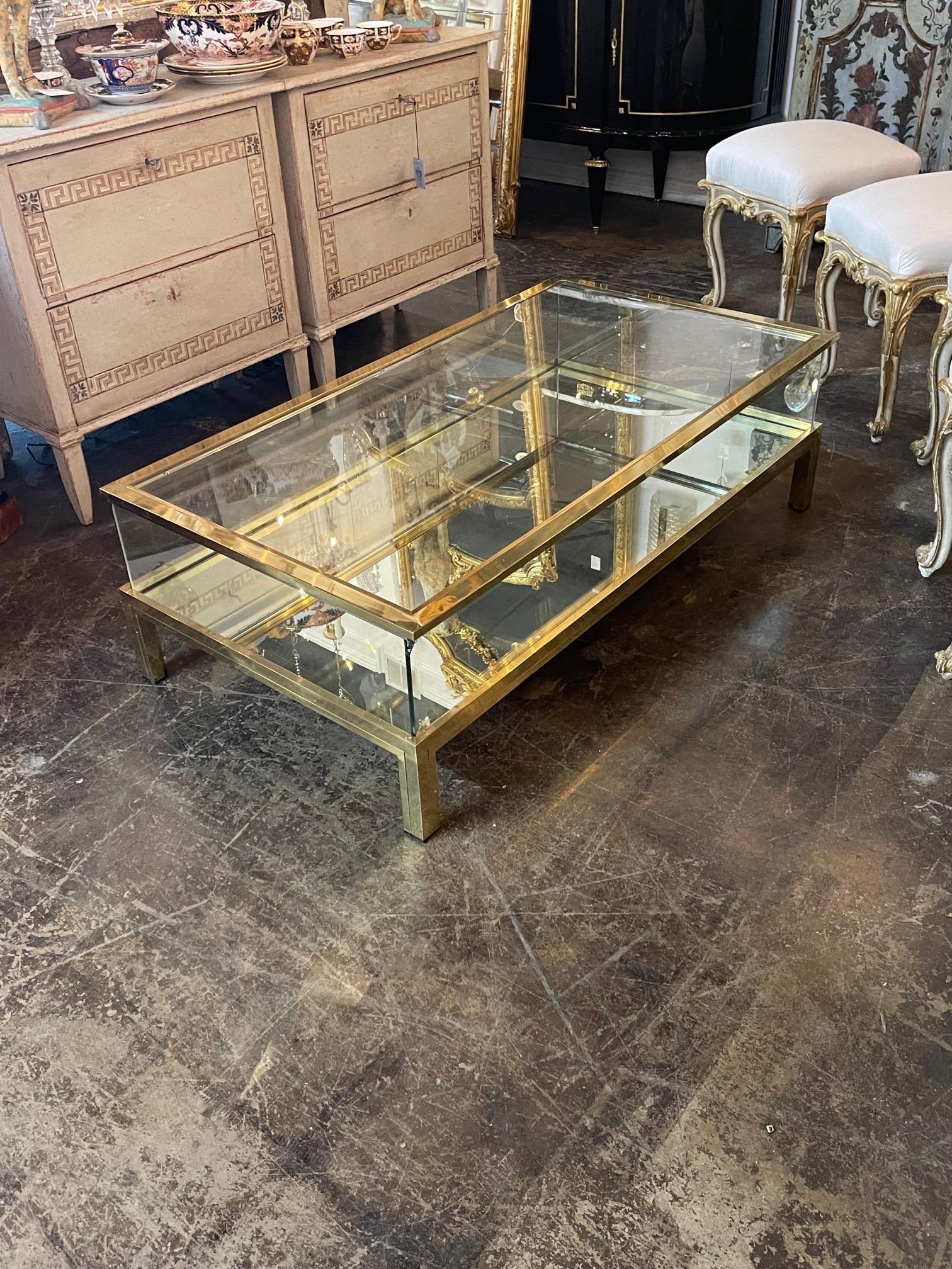 Beautiful French Maison Jansen style case coffee table. The bottom section of glass is mirrored and the top is removeable so the you can put items inside for display if you wish. A lovely and stylish table!