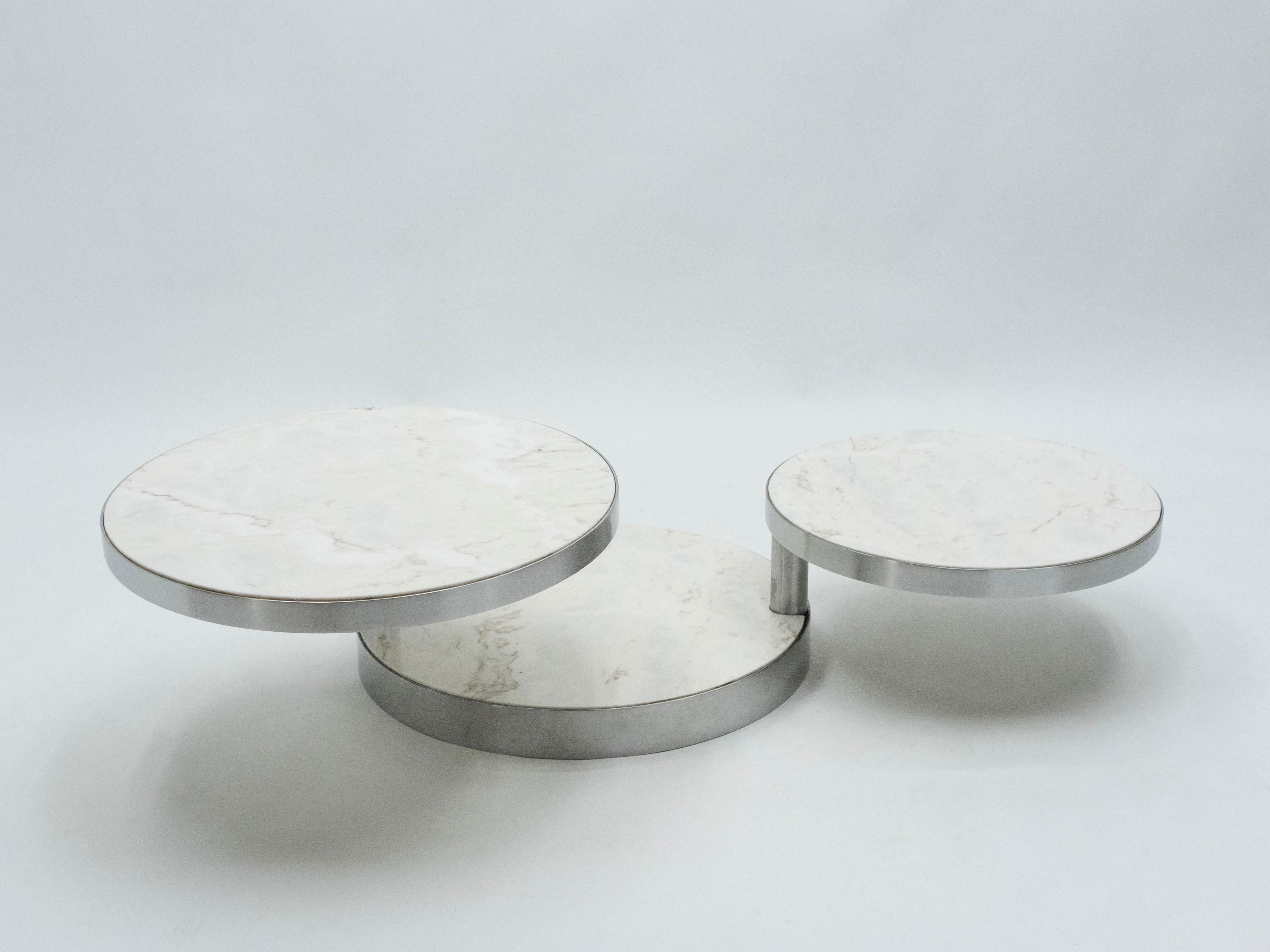 A rare Maison Mercier rounded three-tier swivel table made in France in the early 1970s. It features a brushed steel frame and structure with three white marble levels that can be adjusted and fixed by two handels. This is a quite rare and unique