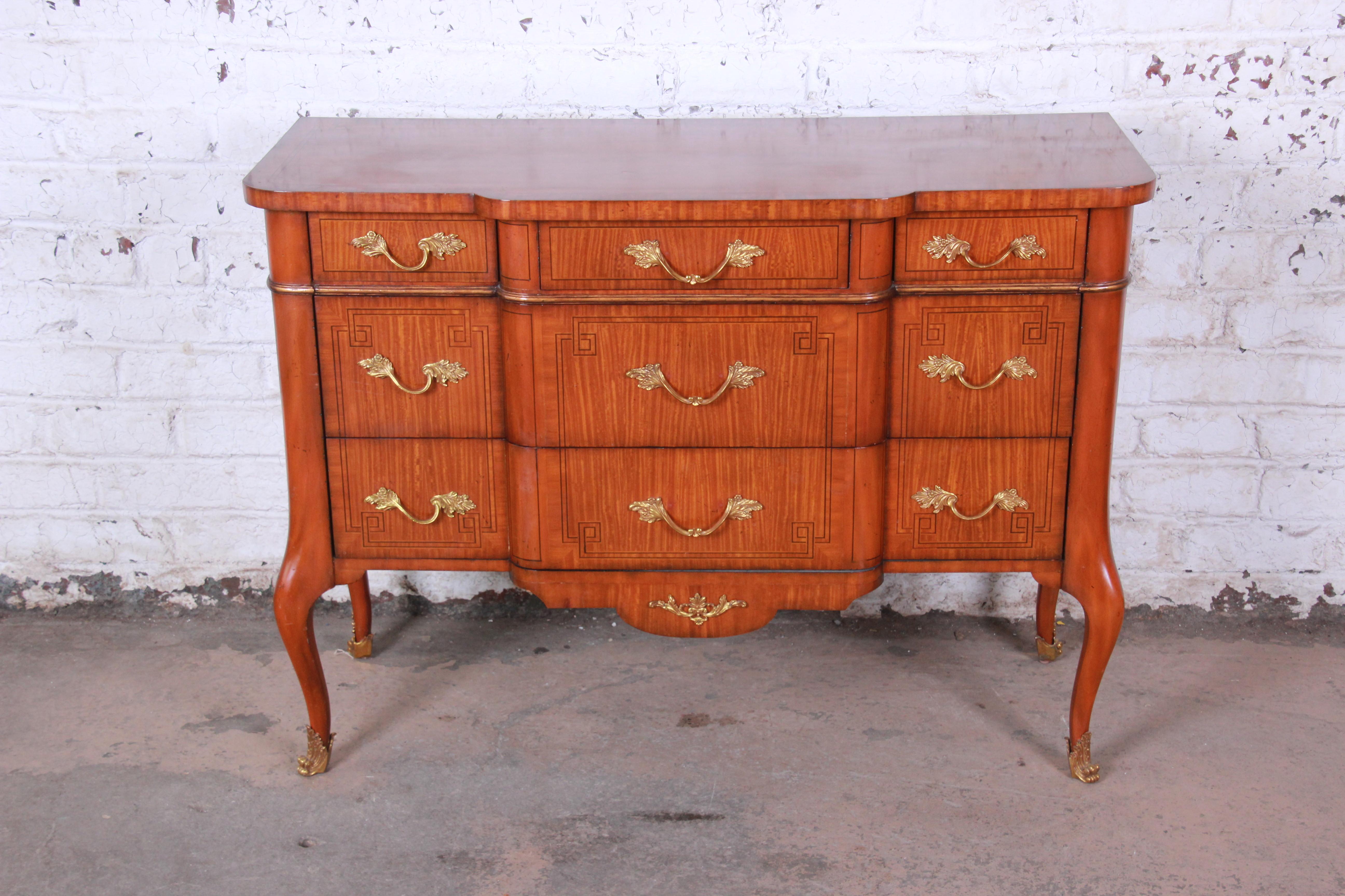 Offering a very nice Maitland-Smith banded and inlaid satinwood dresser or server. The piece has five drawers that offer lots or room for storage and organization. The piece has beautiful inlaid designs and bronze ormolu and brass details