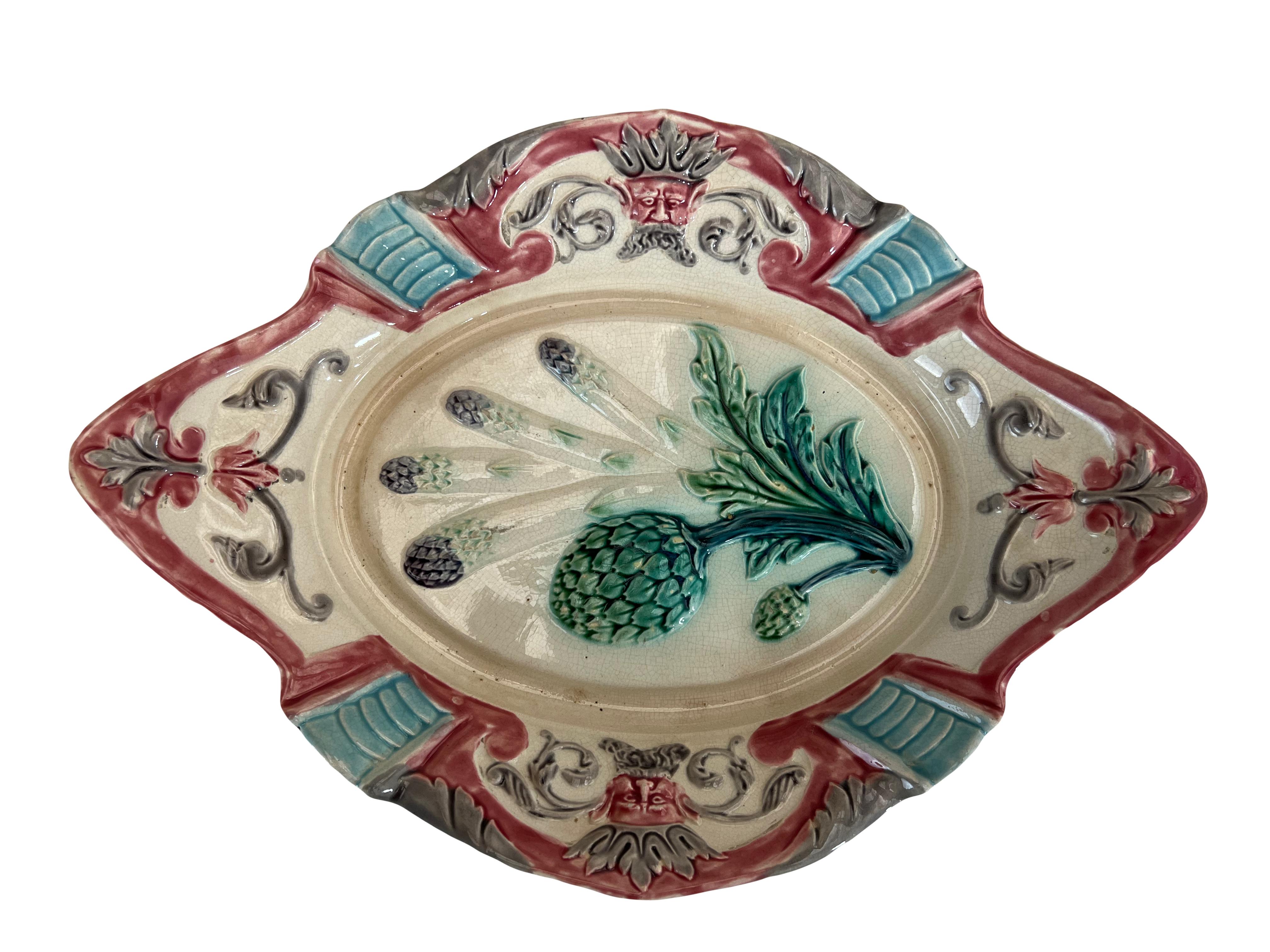 Set of 6 French majolica plates and a platter by Fives-Lille, dating back to around 1890. Designed to serve both artichokes and asparagus, these pieces feature images of both plants. Green glazing is applied on a white background, with deep purple