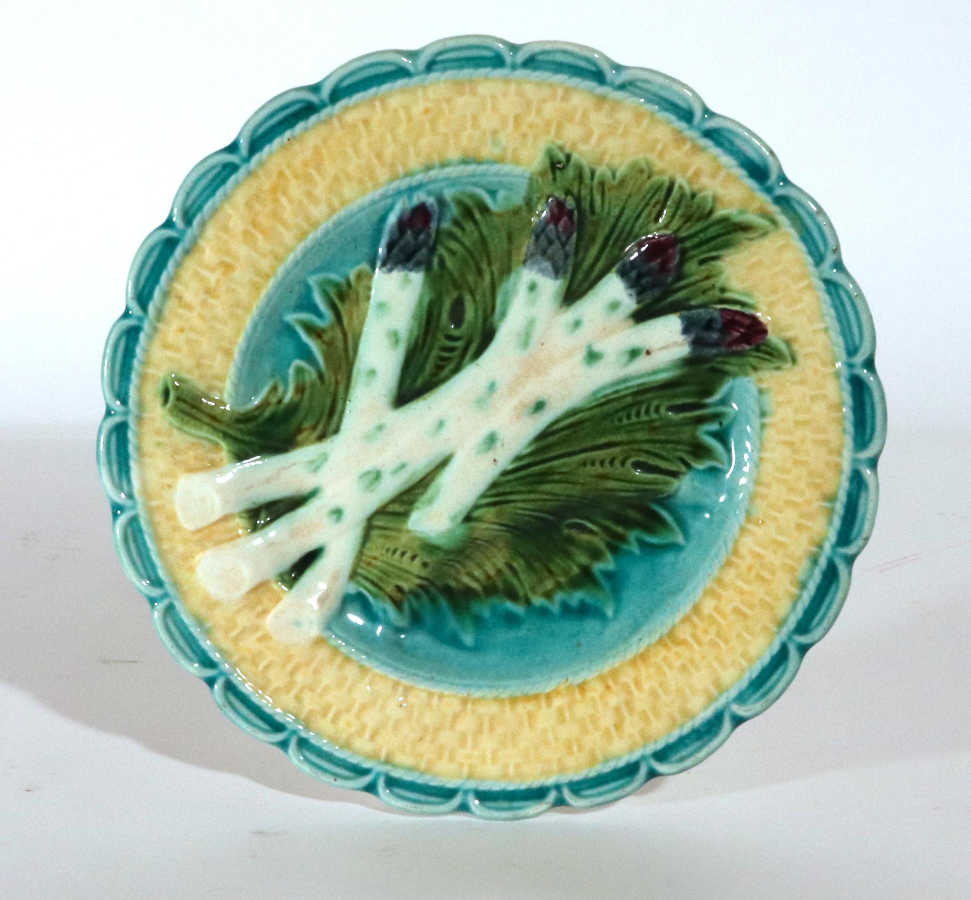 French Majolica Asparagus Dishes, 
Salins Factory,  
Set of Six,
Circa 1880-90

The French majolica molded plates decorated with four asparagus placed on a large green leaf with a yellow basket-weave border and an aqua blue shaped rim.

Dimensions: