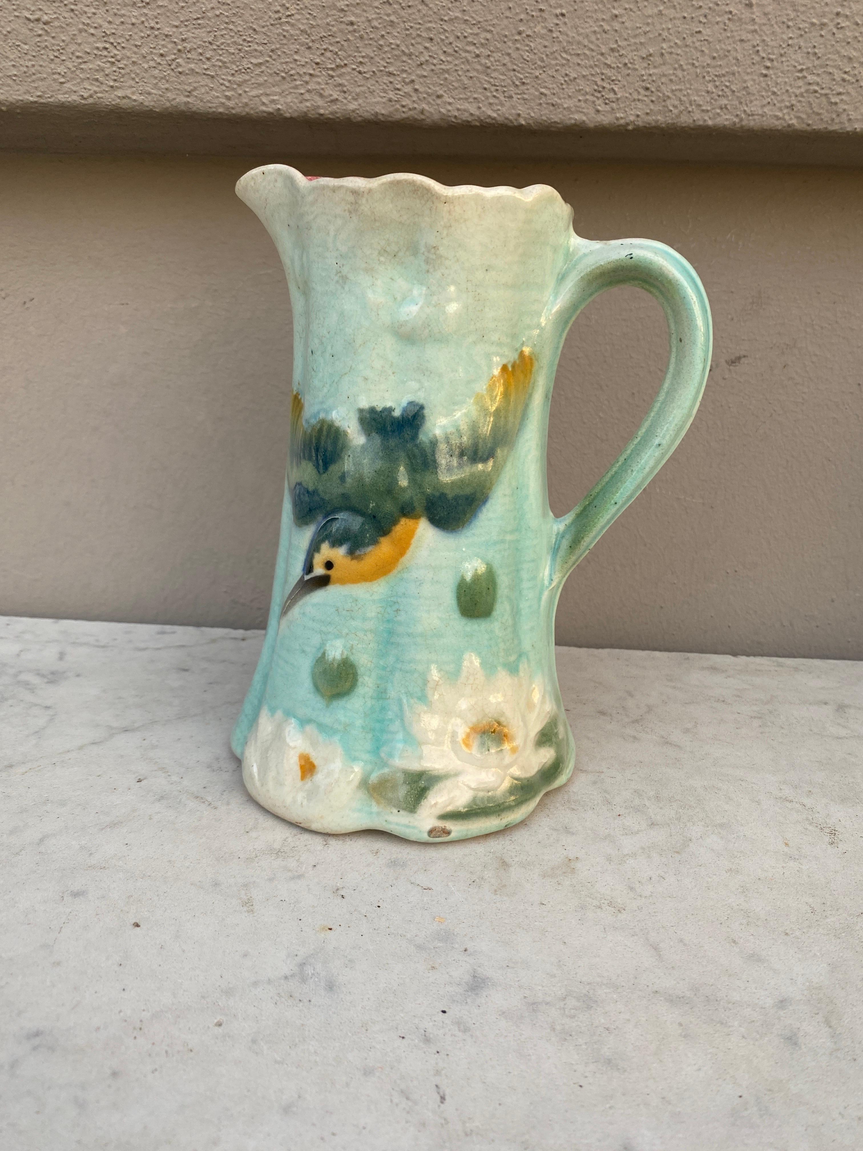 French Majolica pitcher with a bird and water lilies signed Keller & Guerin Saint Clément, circa 1900.
 