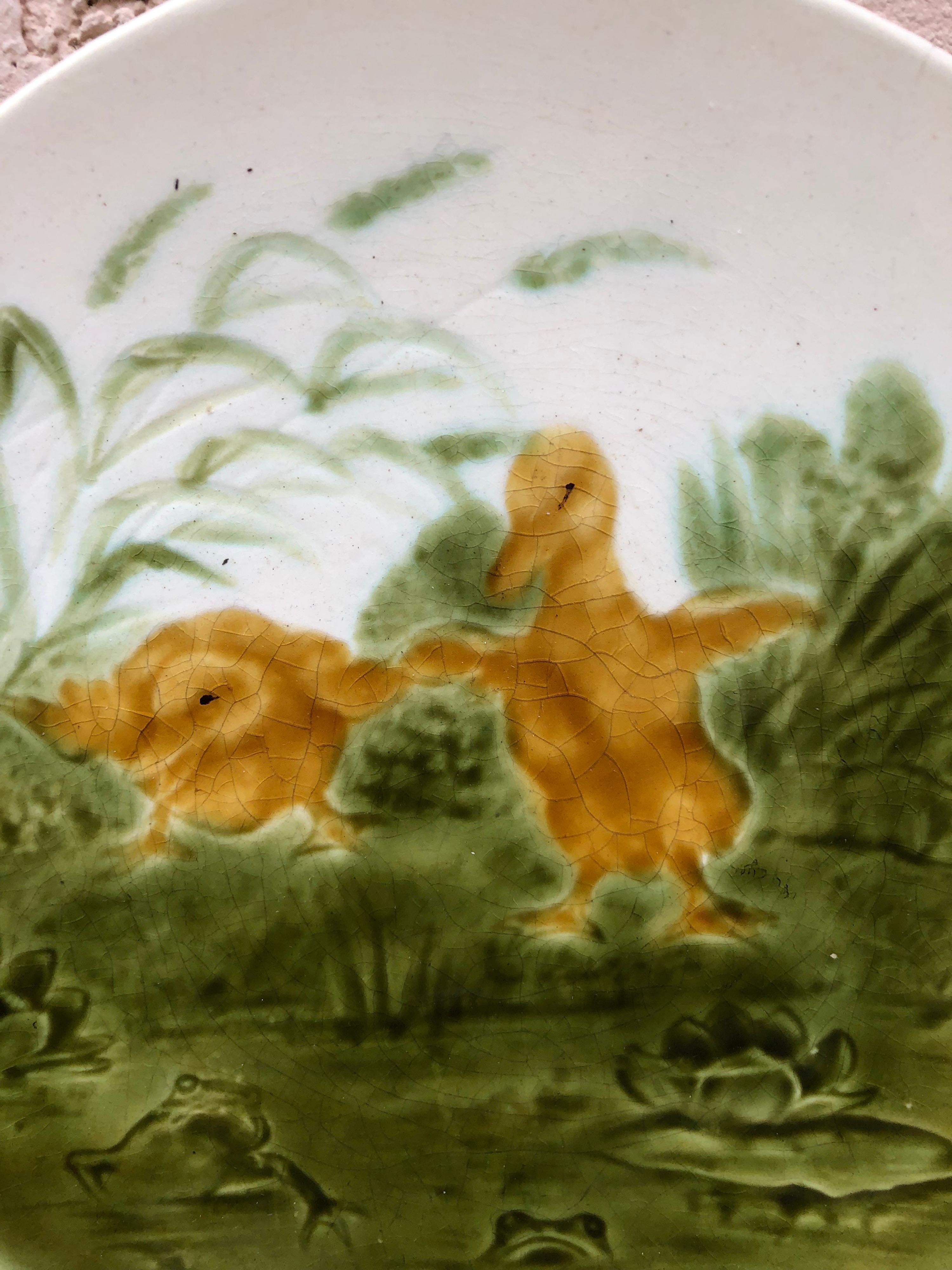 French Majolica ducklings with frogs plate signed Sarreguemines, circa 1890.