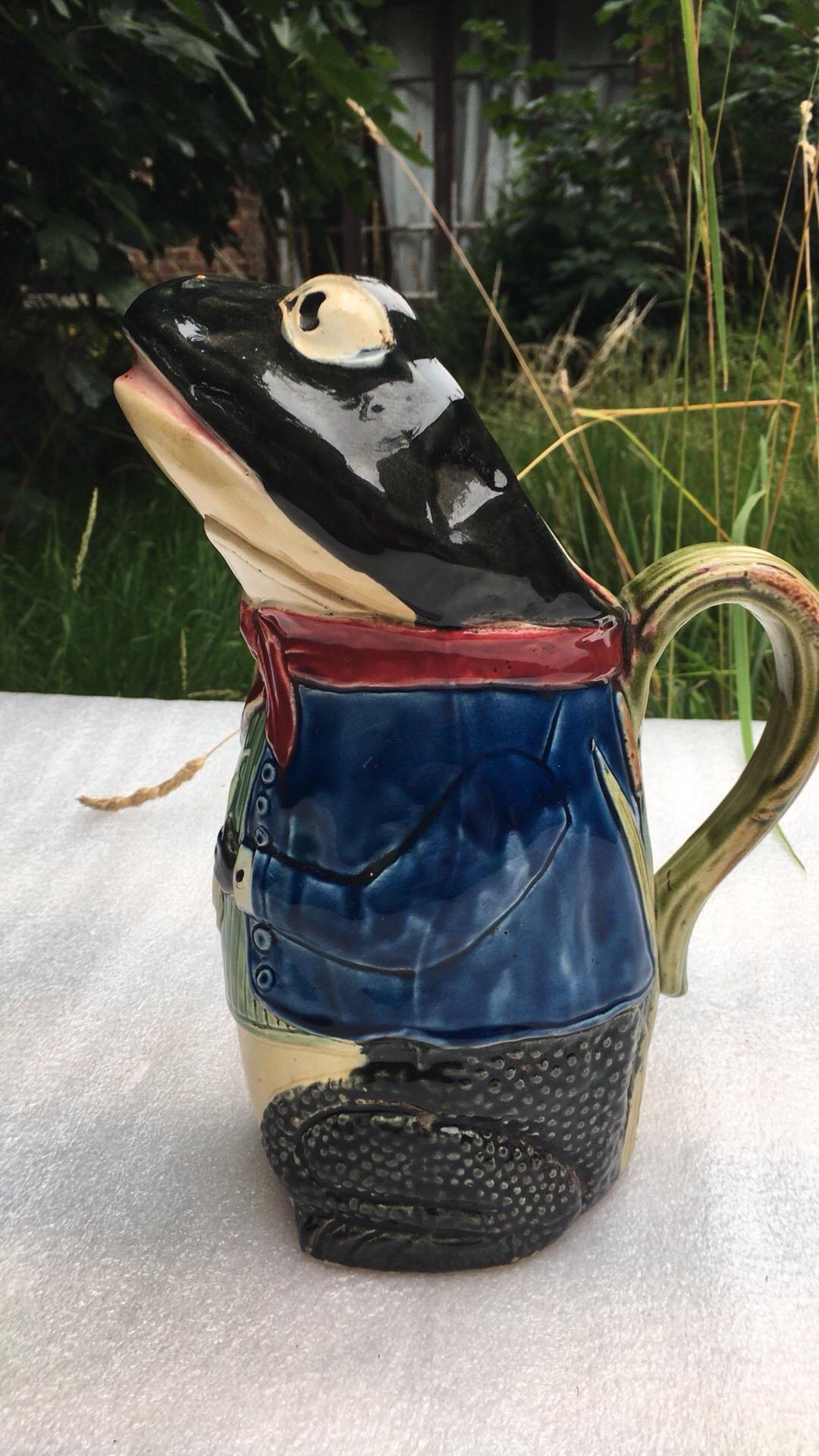 Unusual Majolica frog pitcher wearing a blue jacket signed Fives Lille, circa 1890.