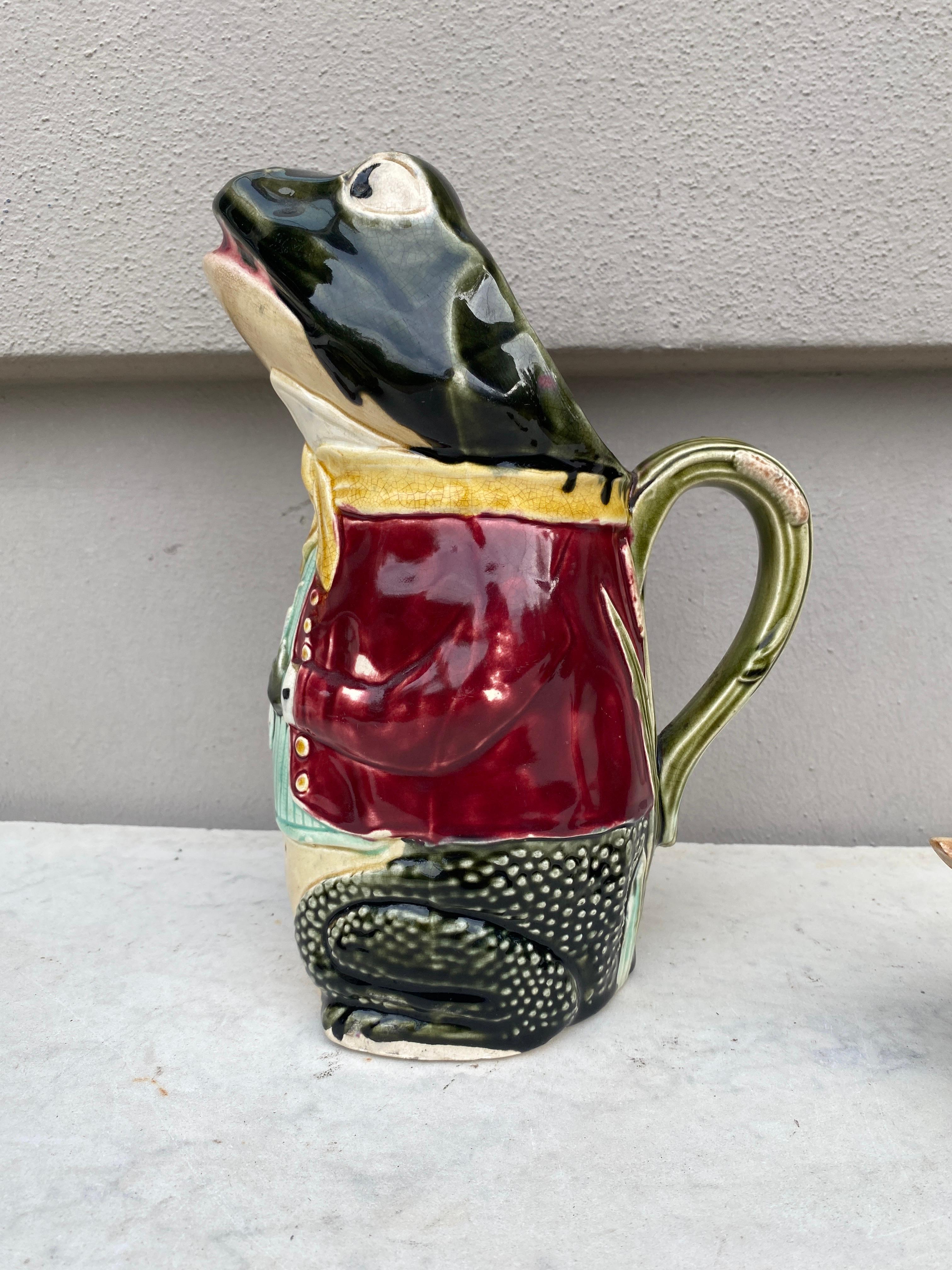 Unusual Majolica frog pitcher wearing a red jacket signed Fives Lille, circa 1890.
