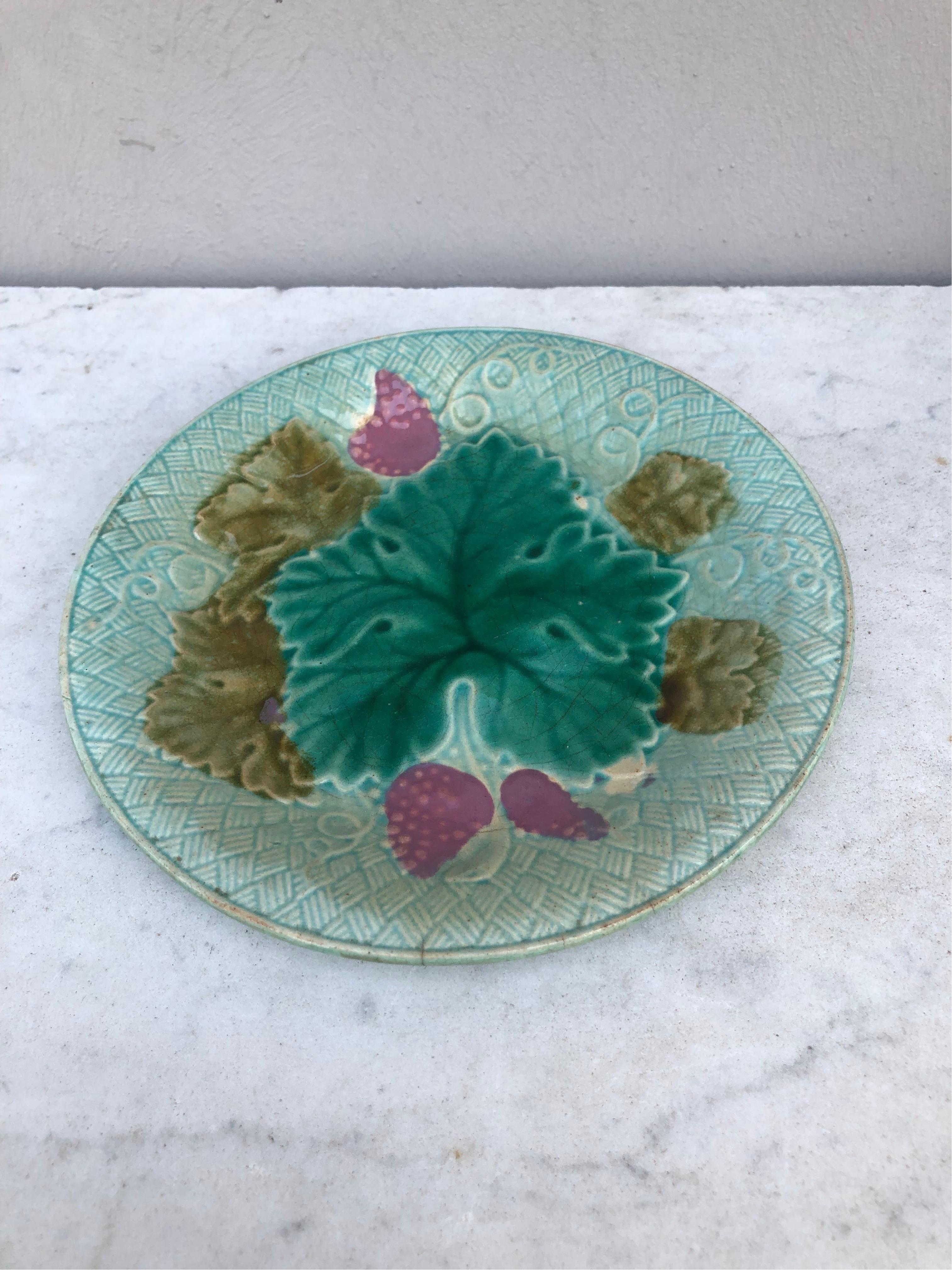 French Majolica grapes plate Salins on a light blue background (East of France), circa 1890.
