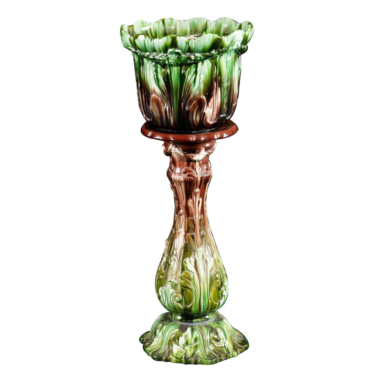 French majolica jardinière & pedestal set, early 20th century.
 

Signed on underside
The molded pottery pot in an Art Nouveau design rendered in greens and burgundy tones
 
Dimensions

46