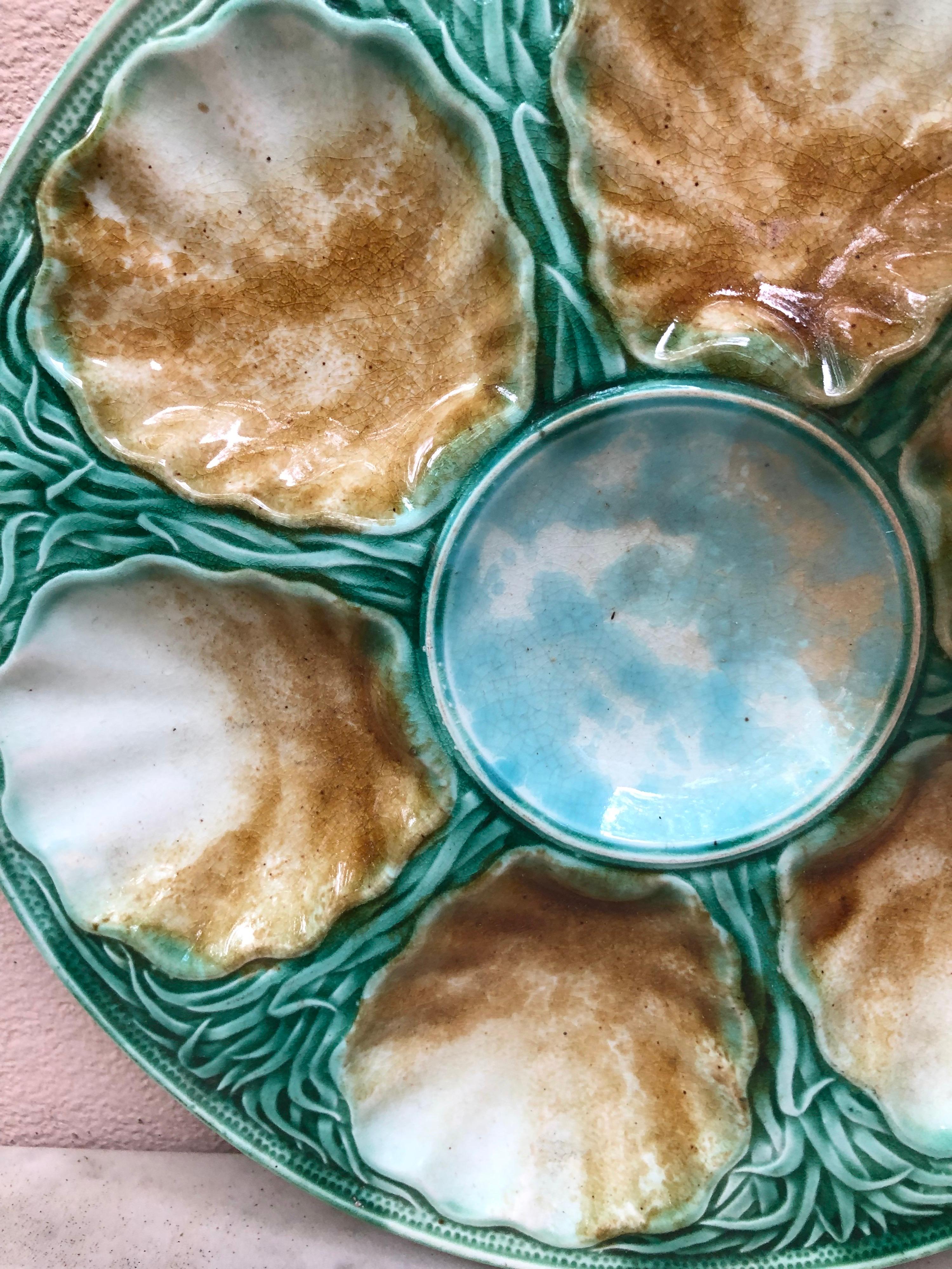 French Majolica oyster plate with seaweeds signed Salins ( East of France ), circa 1890.