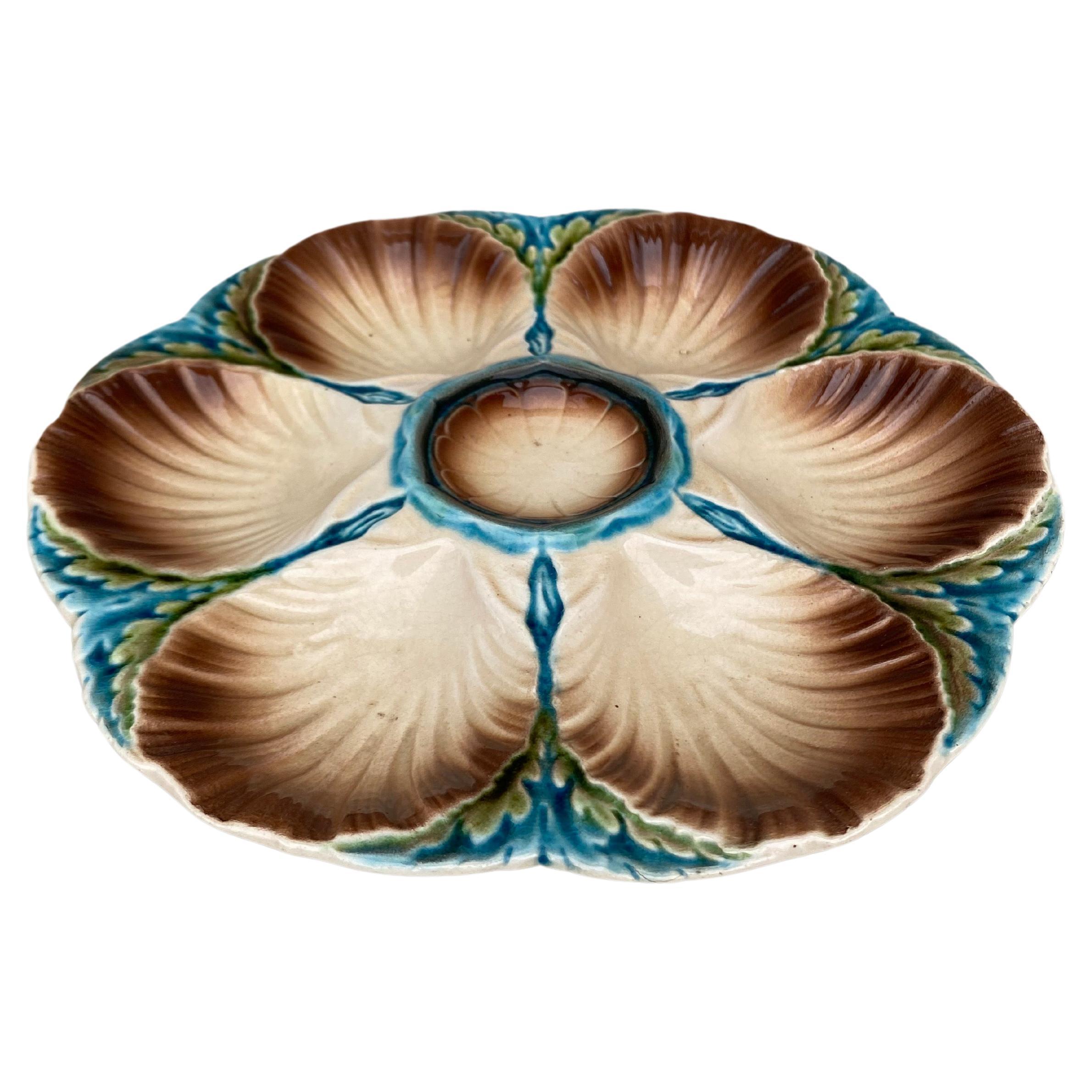 Majolica oyster plate Sarreguemines, circa 1890.
6 shells and space for the lemon on the center.